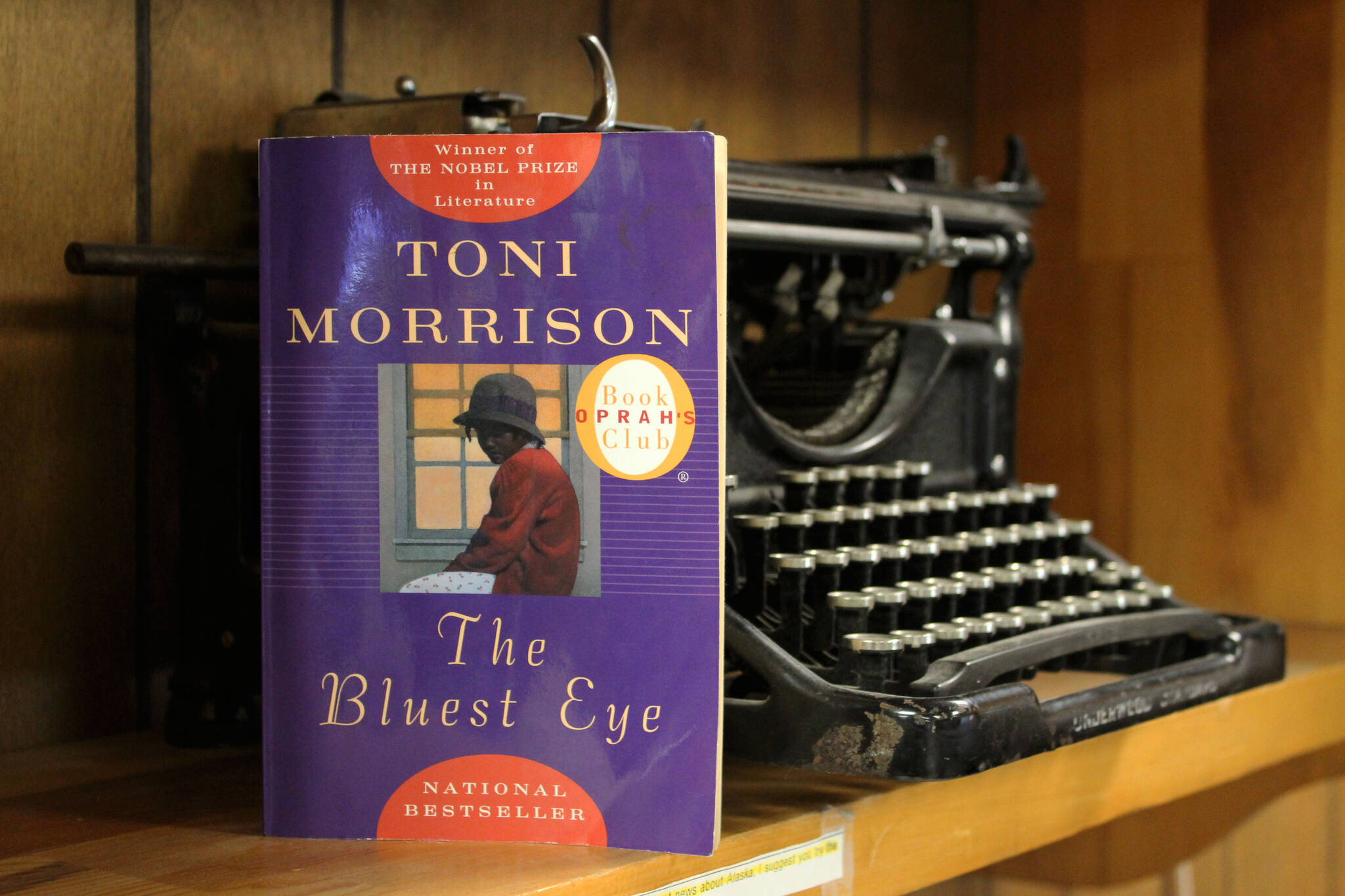 A copy of Toni Morrison’s “The Bluest Eye” rests against a typewriter on Wednesday, April 6, 2022, in Kenai, Alaska. (Ashlyn O’Hara/Peninsula Clarion)