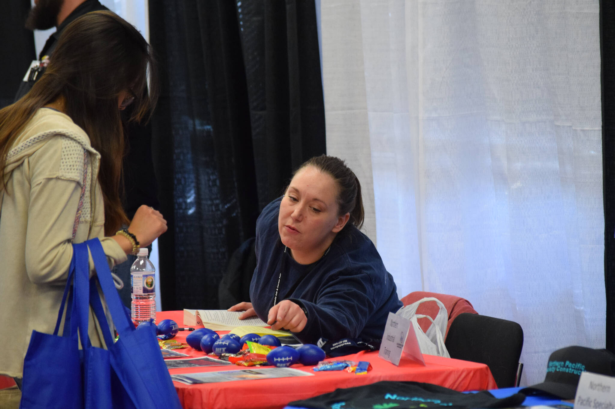 Community members participate in the Kenai Peninsula Job and Career Fair at the Soldotna Regional Sports Complex on Thursday, April 7, 2022, in Soldotna, Alaska. (Camille Botello/Peninsula Clarion)