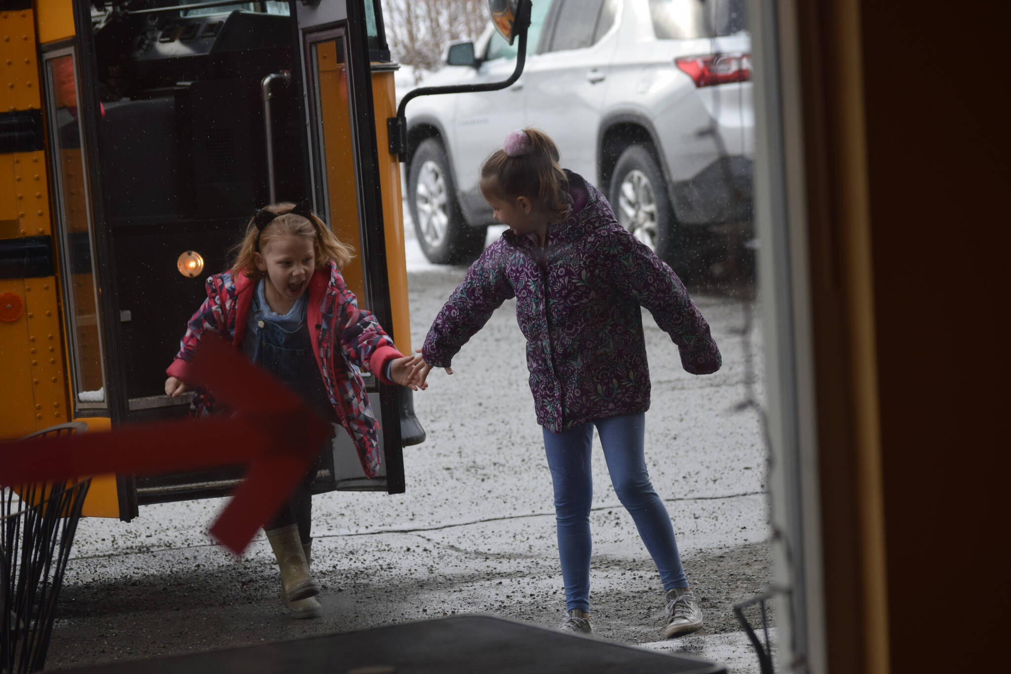 The Soldotna Elementary School kindergarten class runs into Kaladi Brothers Coffee on South Kobuk Street in Soldotna, Alaska, on Friday, April 8, 2022, to look at their art show. (Camille Botello/Peninsula Clarion)