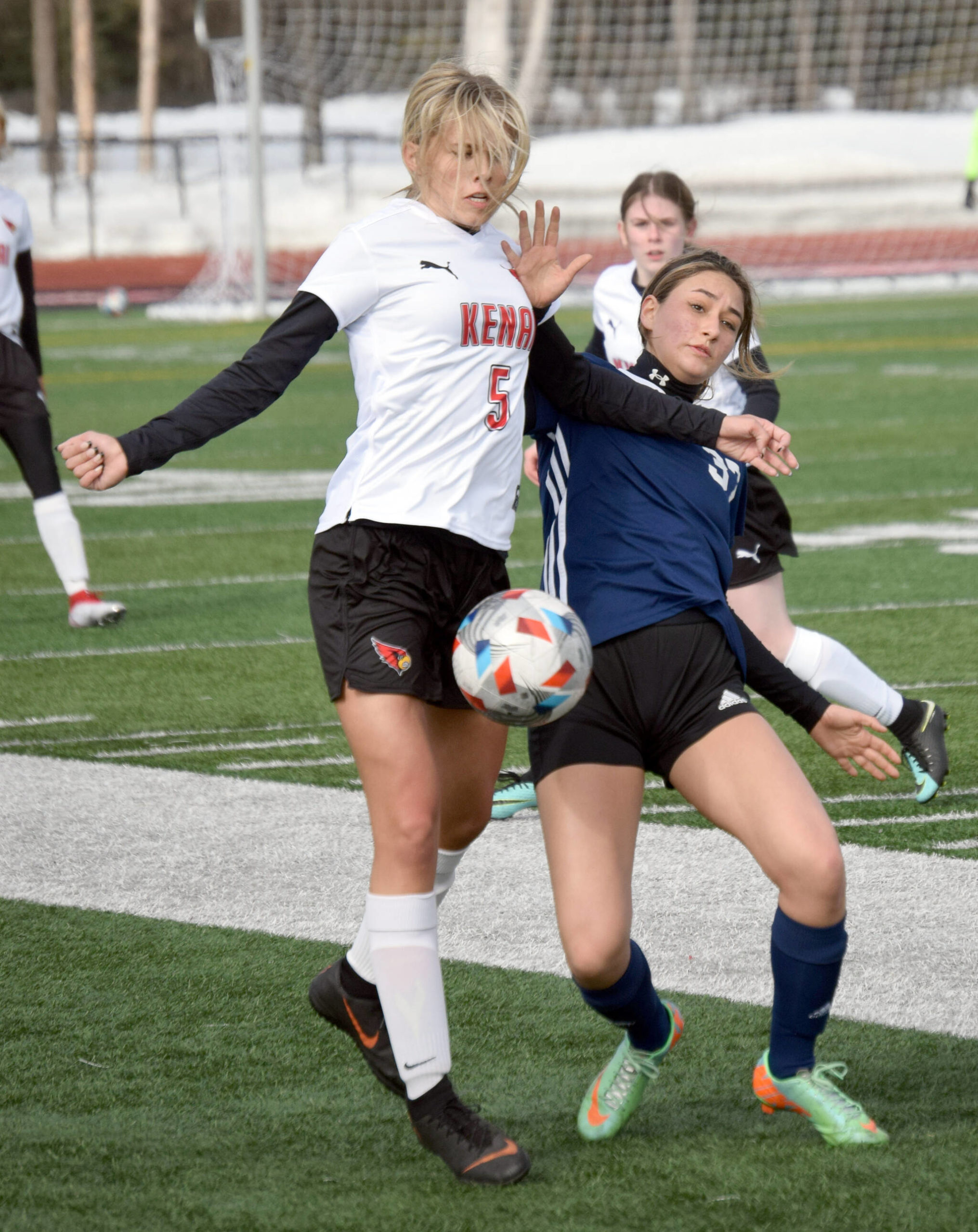 Kenai Centrals Chloe Goldsby and Soldotnas Zayra Poage battle for the ball Friday, April 8, 2022, at Kenai Central High School in Kenai, Alaska. (Photo by Jeff Helminiak/Peninsula Clarion)