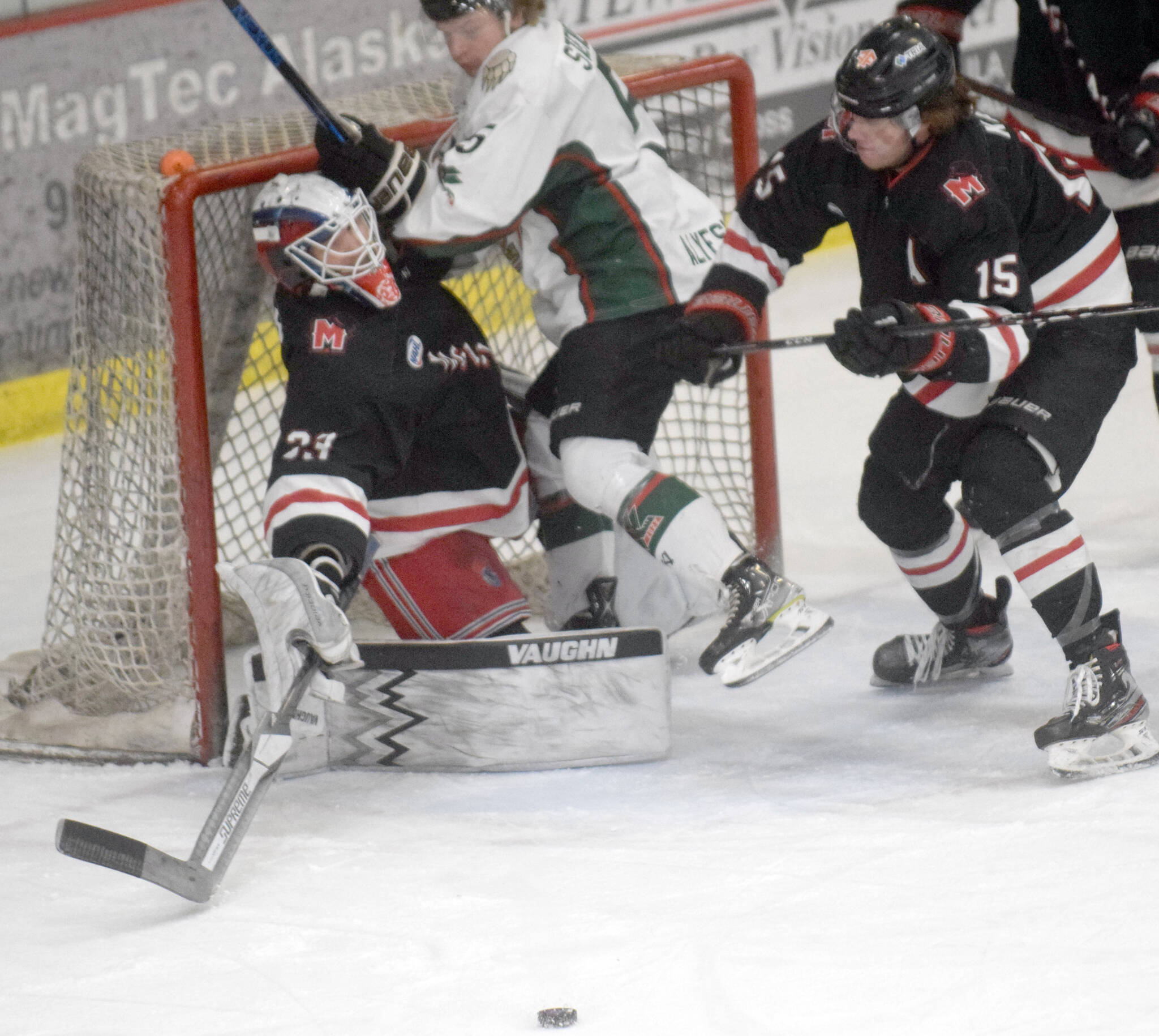 Kenai River Brown Bears forward Nick Stevens runs into Minnesota Magicians goalie Josh Langford on Saturday, April 9, 2022, at the Soldotna Regional Sports Complex in Soldotna, Alaska. (Photo by Jeff Helminiak/Peninsula Clarion)