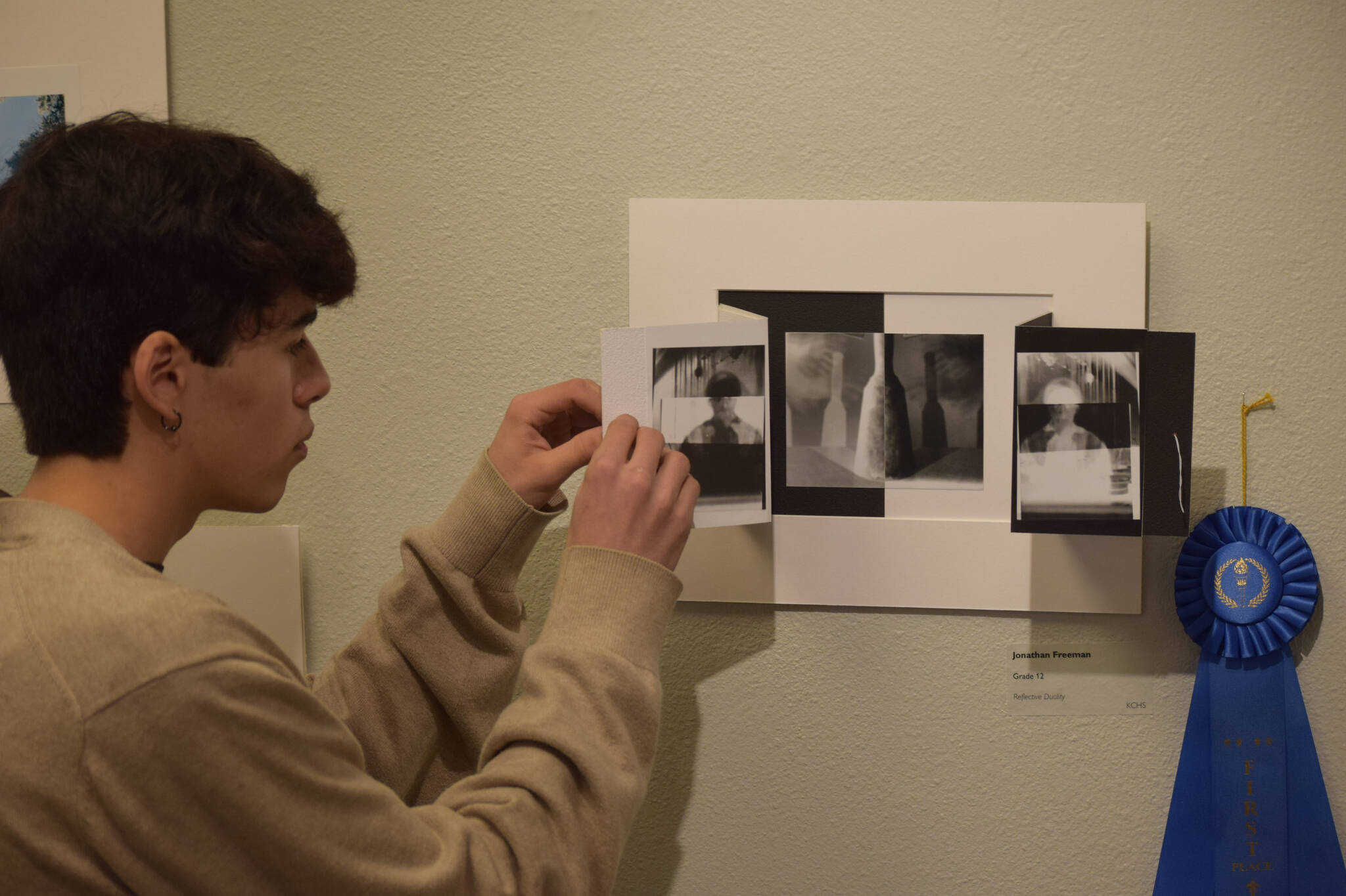 Jonathan Freeman displays his first place photography piece during the opening reception of the Kenai Art Center’s annual student show on Thursday, April 7, 2022. (Camille Botello/Peninsula Clarion)