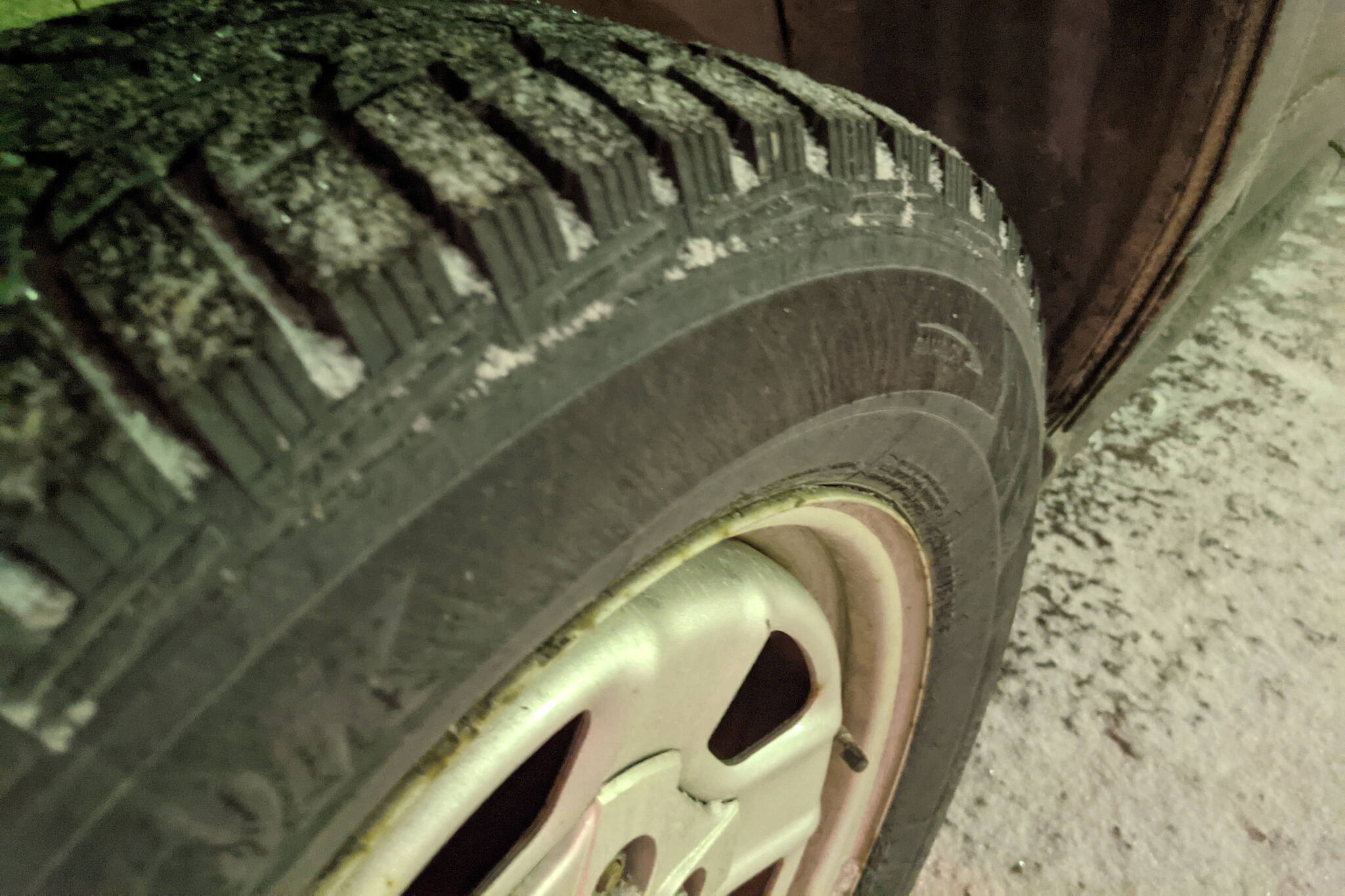 Snow falls on studded tires on Wednesday, April 7, 2021, in Kenai, Alaska. For Alaskans living above the 60 North Latitude line, which includes all portions of the Sterling Highway, studded tires must be removed by May 1, 2022. (Peninsula Clarion file)