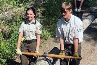 YCC Enrollees harvest beetle-killed spruce for a facility enhancement project. (Photo by Nick Longobardi/FWS)