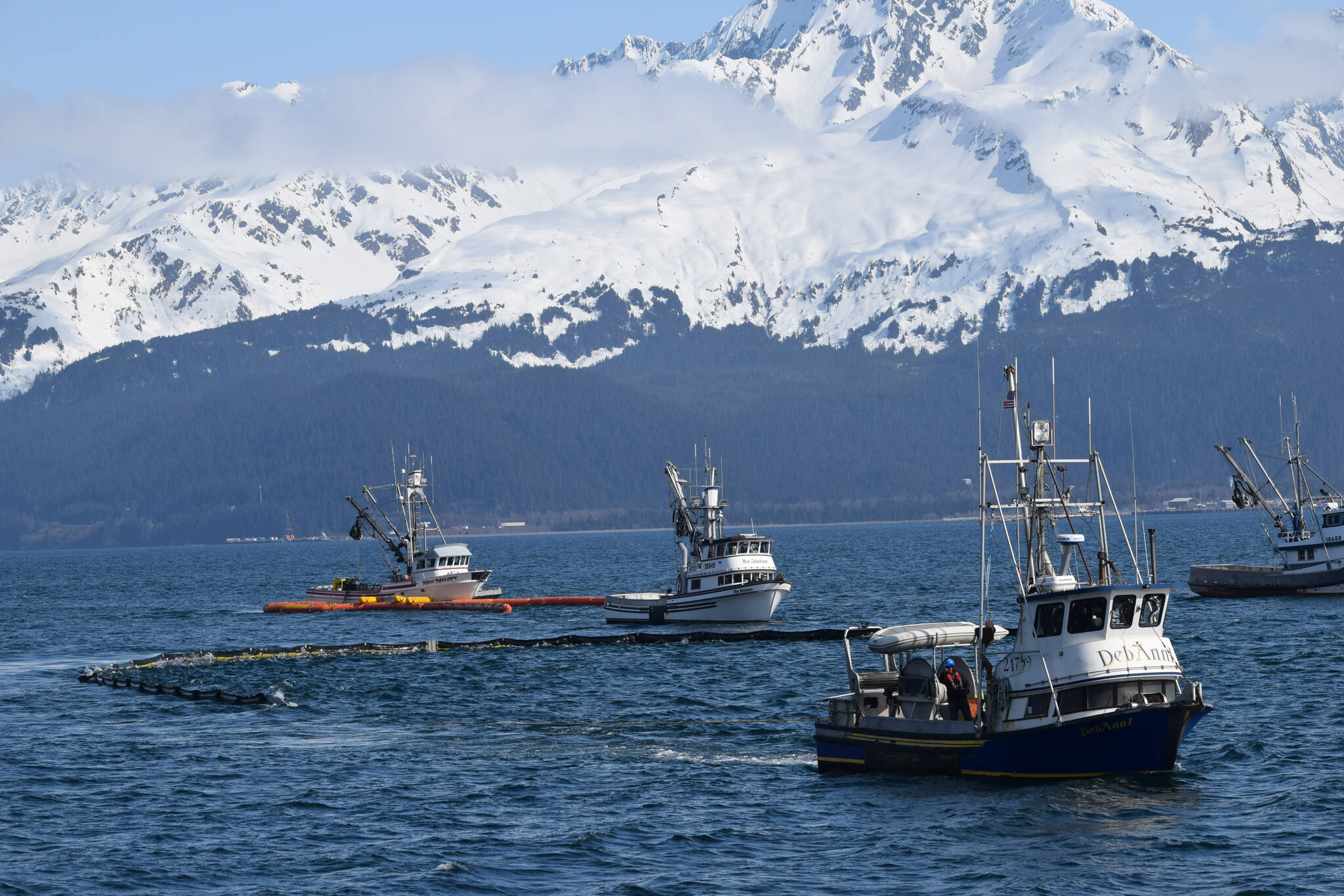 A fishing vessel fleet off the coast of Seward, Alaska, participates in oil spill response training hosted by the Prince William Sound Regional Citizens’ Advisory Council (RCAC), along with members of the Alyeska Pipeline Service Company, on Thursday, April 14, 2022. (Camille Botello/Peninsula Clarion)