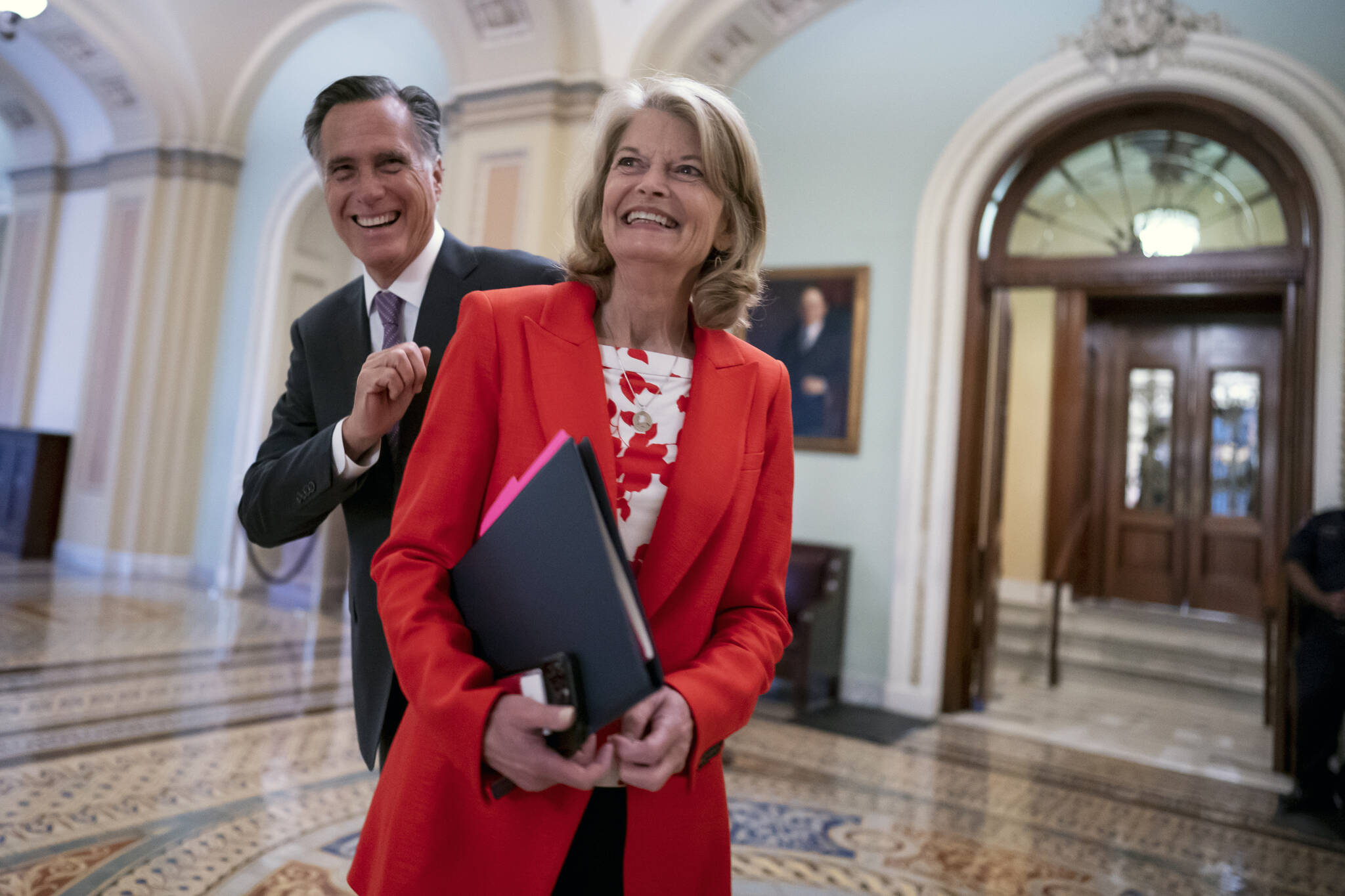 Republican Sens. Lisa Murkowski, of Alaska, and Mitt Romney of Utah, left, who say they will vote to confirm Judge Ketanji Brown Jackson’s historic nomination to the Supreme Court, smile as they greet each other outside the chamber, at the Capitol in Washington, Tuesday, April 5, 2022. Murkowski continues to have a substantial cash advantage over her opponent backed by former President Donald Trump, who has vowed revenge on the incumbent Alaska Republican. Murkowski brought in more than $1.5 million in the three-month period ending March 31, 2022, according to Federal Election Commission filings. (AP Photo/J. Scott Applewhite, File)