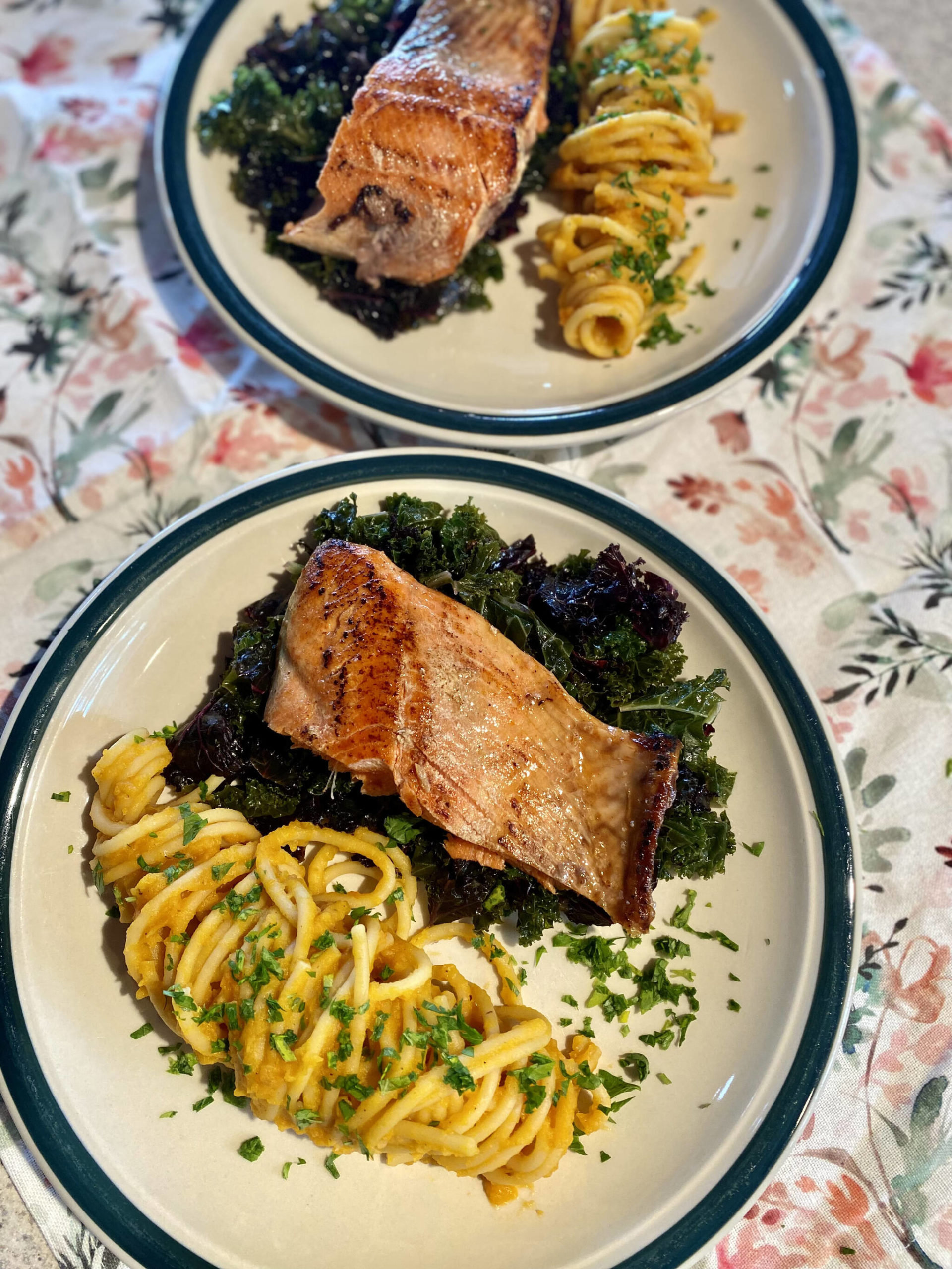 Creamy butternut squash pasta that skips the dairy is served with salmon and greens. (Photo by Tressa Dale/Peninsula Clarion)