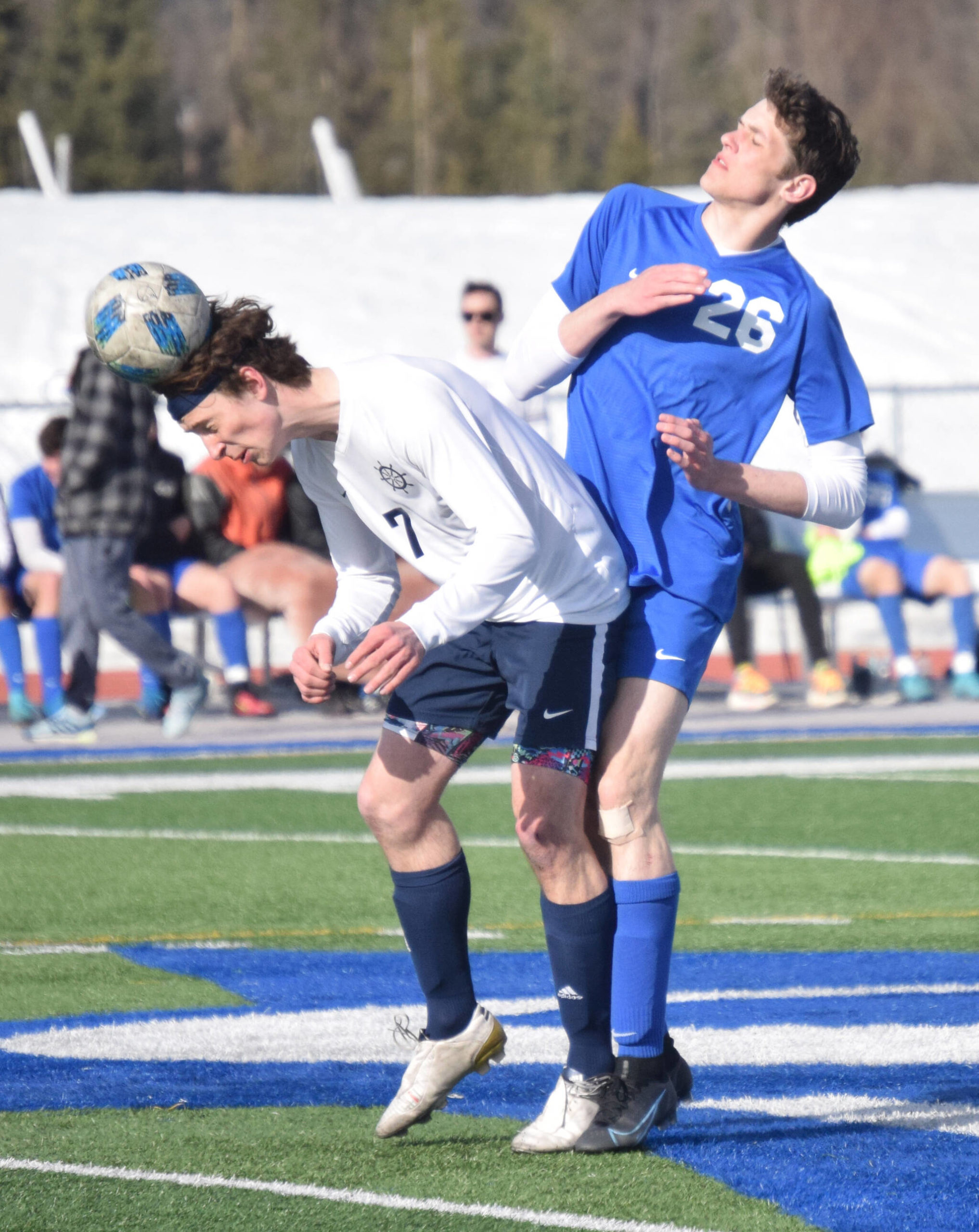 Homer's Jake Tappan heads the ball in front of Soldotna's Hamilton Hunt on Tuesday, April 19, 2022, at Soldotna High School in Soldotna, Alaska. (Photo by Jeff Helminiak/Peninsula Clarion)