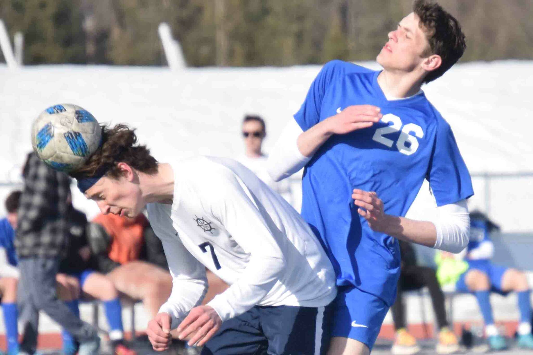 Homer's Jake Tappan heads the ball in front of Soldotna's Hamilton Hunt on Tuesday, April 19, 2022, at Soldotna High School in Soldotna, Alaska. (Photo by Jeff Helminiak/Peninsula Clarion)
