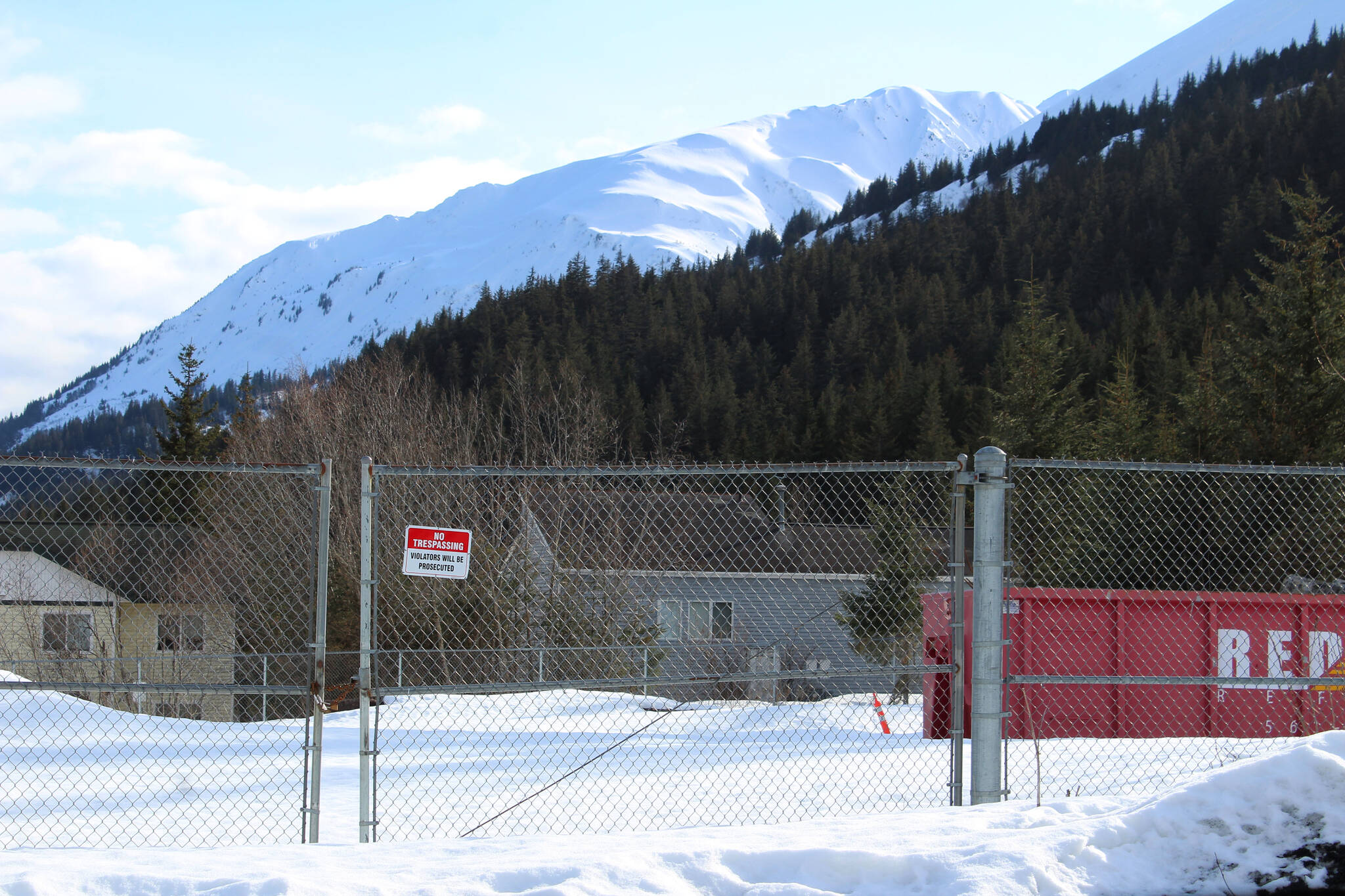 Chain link fencing outlines the site of the former Jesse Lee Home on Sunday, April 3, 2022, in Seward, Alaska. (Ashlyn O’Hara/Peninsula Clarion)