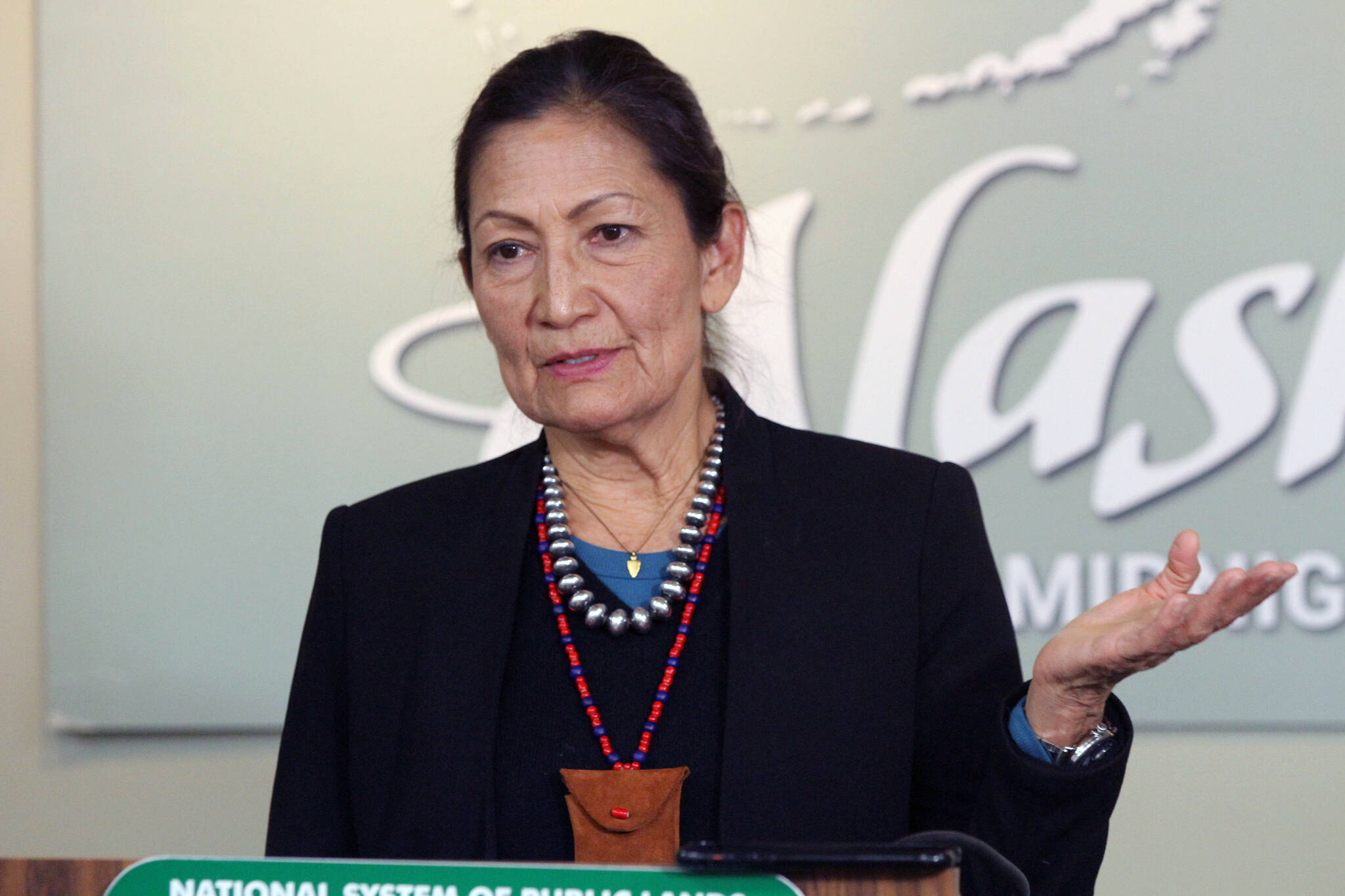 Interior Secretary Deb Haaland gestures while addressing reporters during a news conference Thursday, in Anchorage. Haaland is in the midst of a visit to the state that included a trip to King Cove, a community at the center of a long-running dispute over a proposed land exchange aimed at building a road through a national wildlife refuge. (AP Photo/Mark Thiessen)