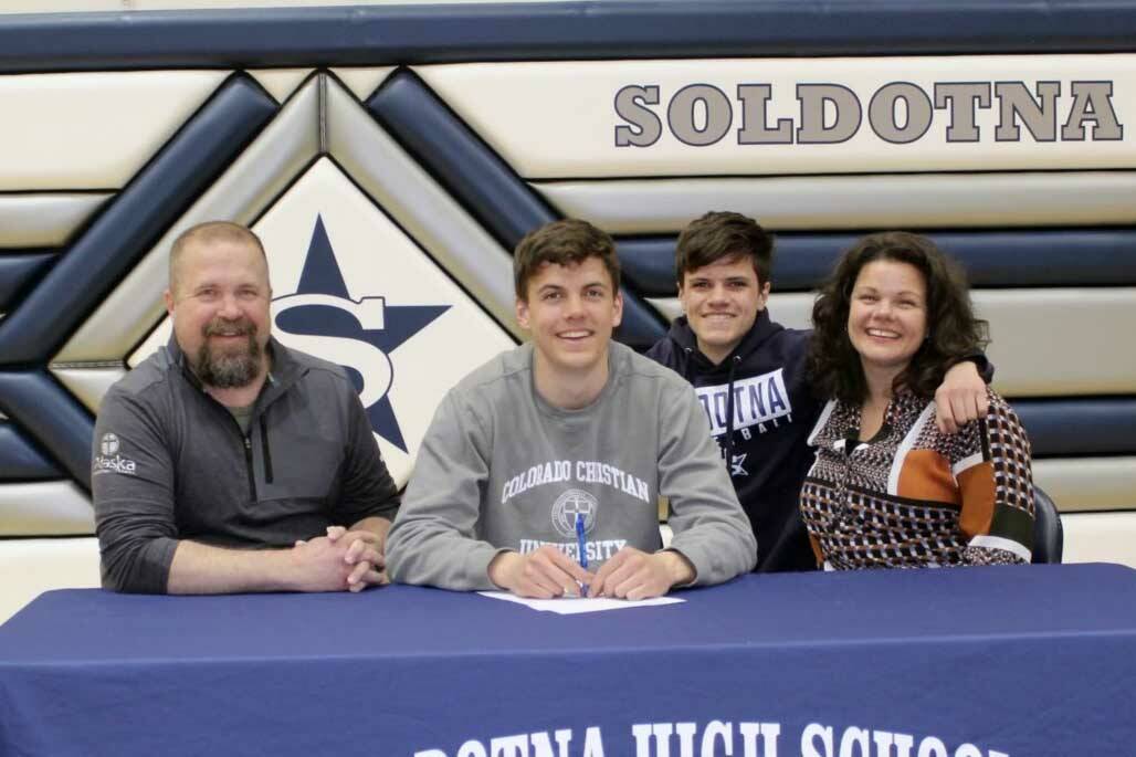 Nate Johnson signs his National Letter of Intent on Friday, April 22, 2022, at Soldotna High School in Soldotna, Alaska. From left to right are Nate's father, Eric; Nate; Nate's brother, Wesley; and Nate's mother, Meghan. (Photo provided)