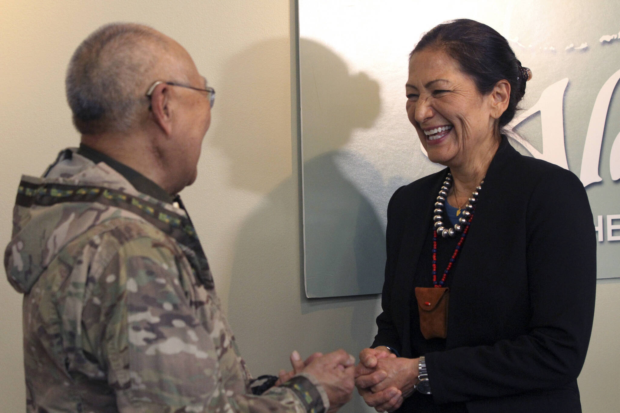 U.S. Interior Secretary Deb Haaland, right, laughs with Nelson Angapak Sr., Thursday, April 21, 2022, in Anchorage, Alaska. Angapak appeared at a news conference with Haaland, who was on a visit to Alaska. (AP Photo/Mark Thiessen)