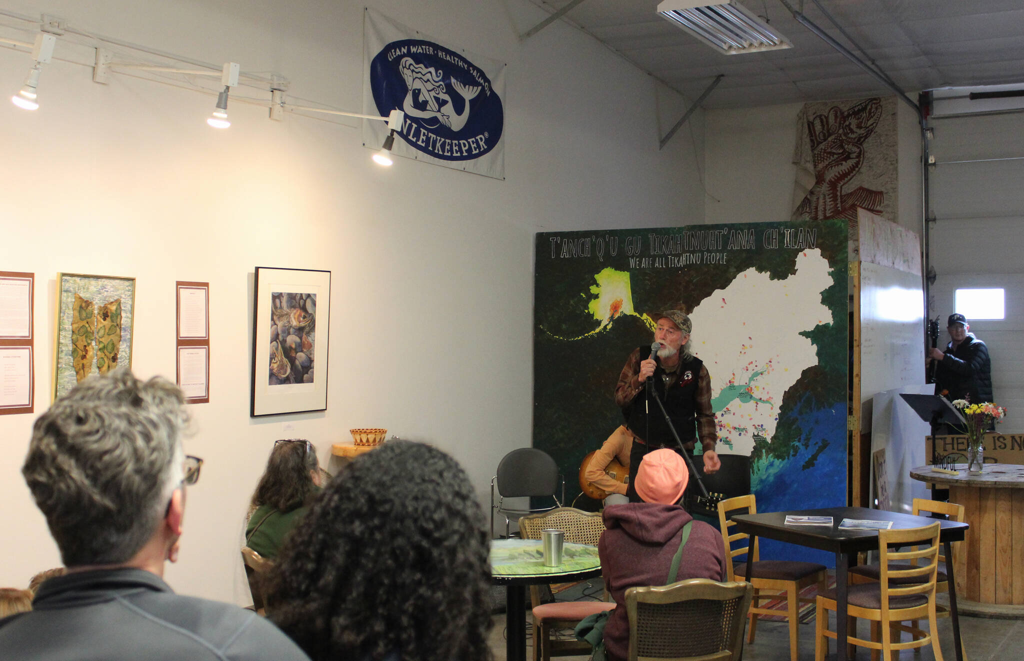 Steve M. Schoonmaker recites poetry as part of the opening of his show “Symbiotic Symphony: Alders and Salmon” at Cook Inletkeeper’s Community Action Studio on Friday, April 22, 2022, in Soldotna, Alaska. (Ashlyn O’Hara/Peninsula Clarion)