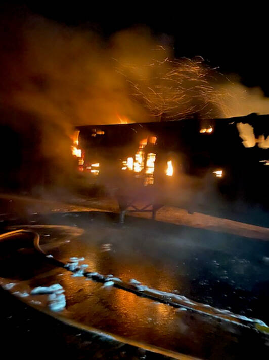 A trailer containing mail for the lower Kenai Peninsula burns on Tuesday, April 26, 2022, on the Seward Highway north of the Seward-Sterling Highway intersection, Alaska. (Photo provided, U.S. Postal Service)