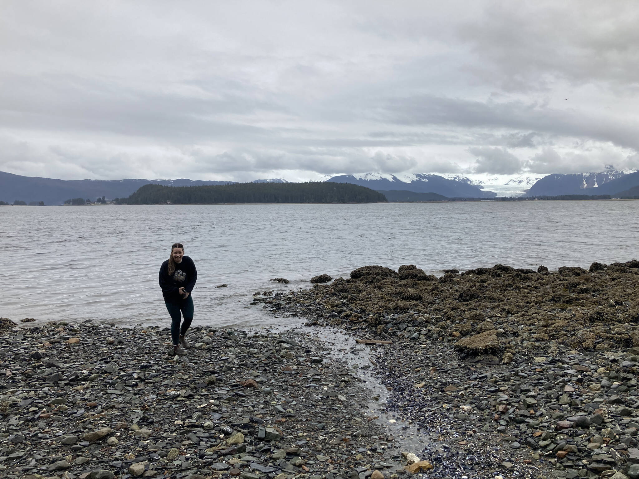 Grace looks for cool rocks on Douglas Island outside of Juneau, Alaska, on Sunday, April 24, 2022. (Camille Botello/Peninsula Clarion)