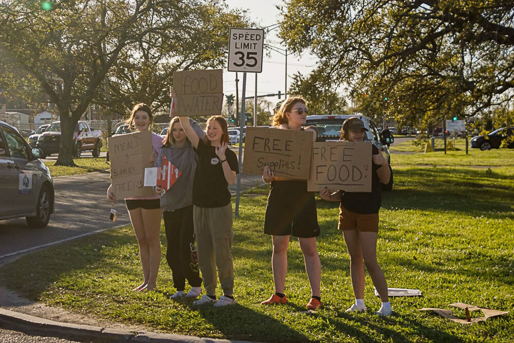 Grace Henry, Anna Nunn, Beka Dillingham, Hope Hillyer, and Rachel Johnson advertise supplies during their mission trip in New Orleans, La., on Thursday, March 24, 2022. (Allie Copeland/CrossRoads Missions New Orleans)