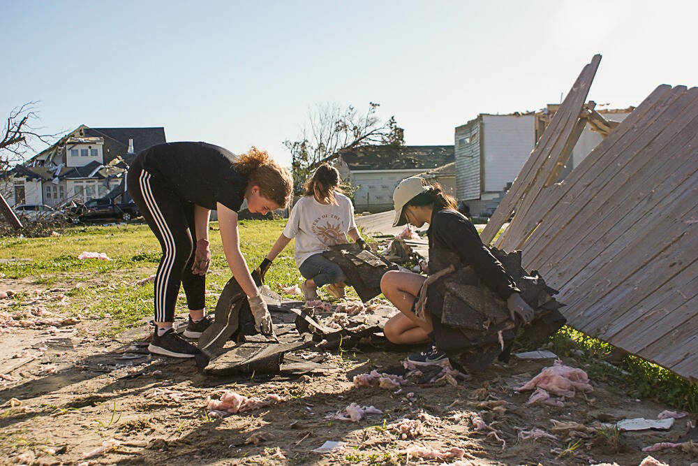 Hope Hillyer, Grace Henry and Rachel Johnson clear debris during their mission trip in New Orleans, La., on Friday, March 25, 2022. (Allie Copeland/CrossRoads Missions New Orleans)