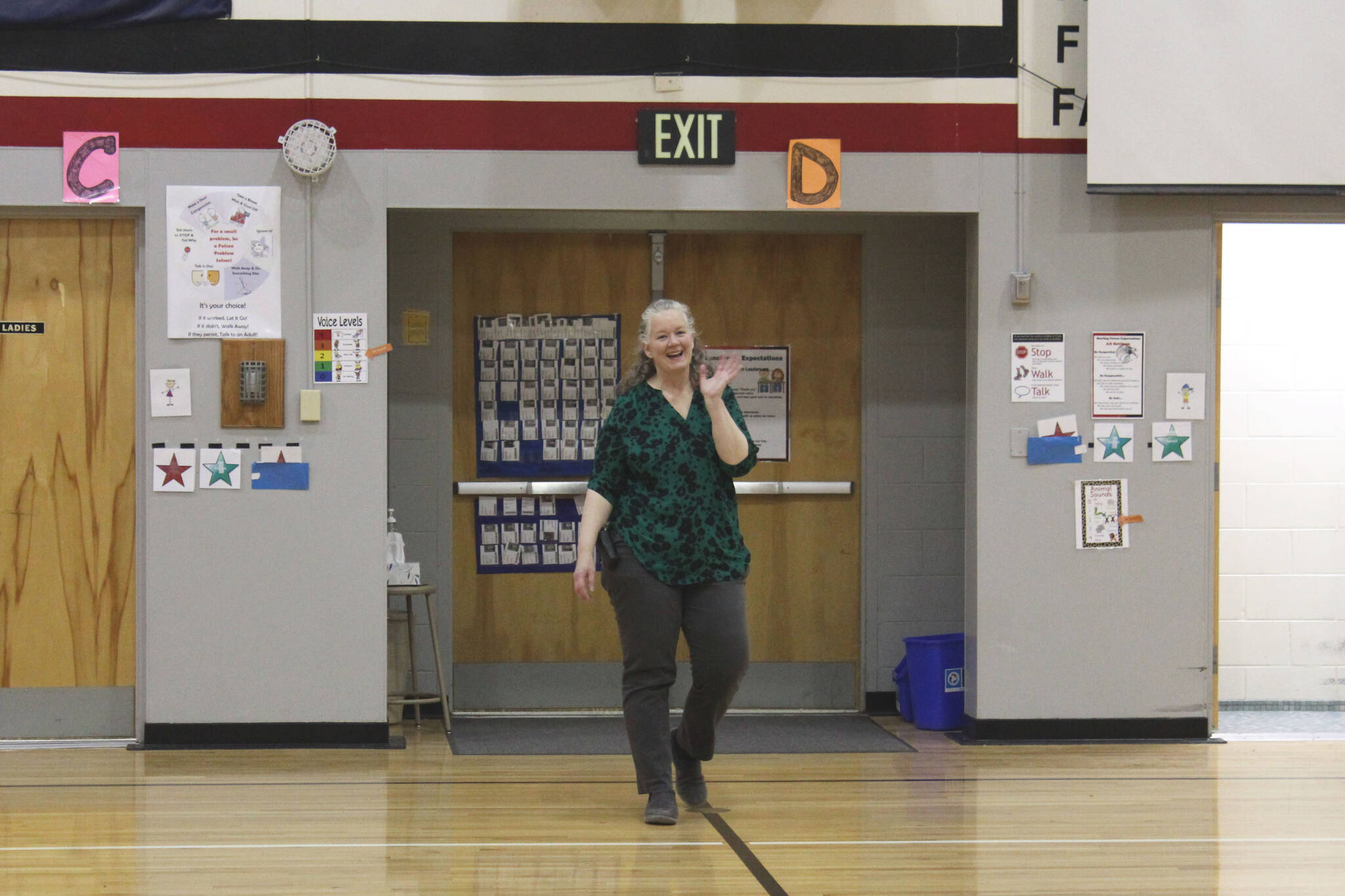 Sterling Elementary School Principal Denise Kelly walks into a surprise assembly to celebrate her being named Alaska Elementary Principal of the Year at Sterling Elementary School on Monday, May 2, 2022, in Sterling, Alaska. (Ashlyn O’Hara/Peninsula Clarion)