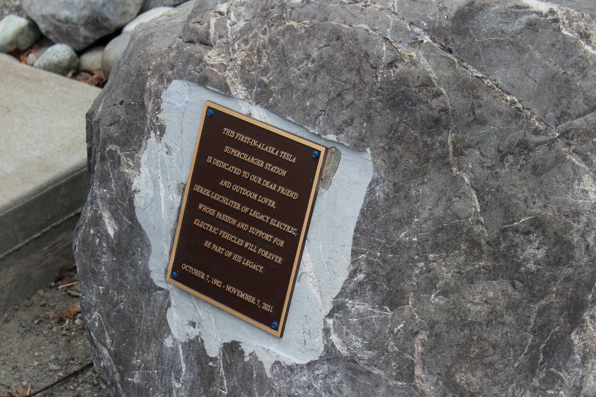 A plaque dedicates Alaska’s first Tesla Supercharger on Saturday, April 30, 2022, in Soldotna, Alaska. (Ashlyn O’Hara/Peninsula Clarion)