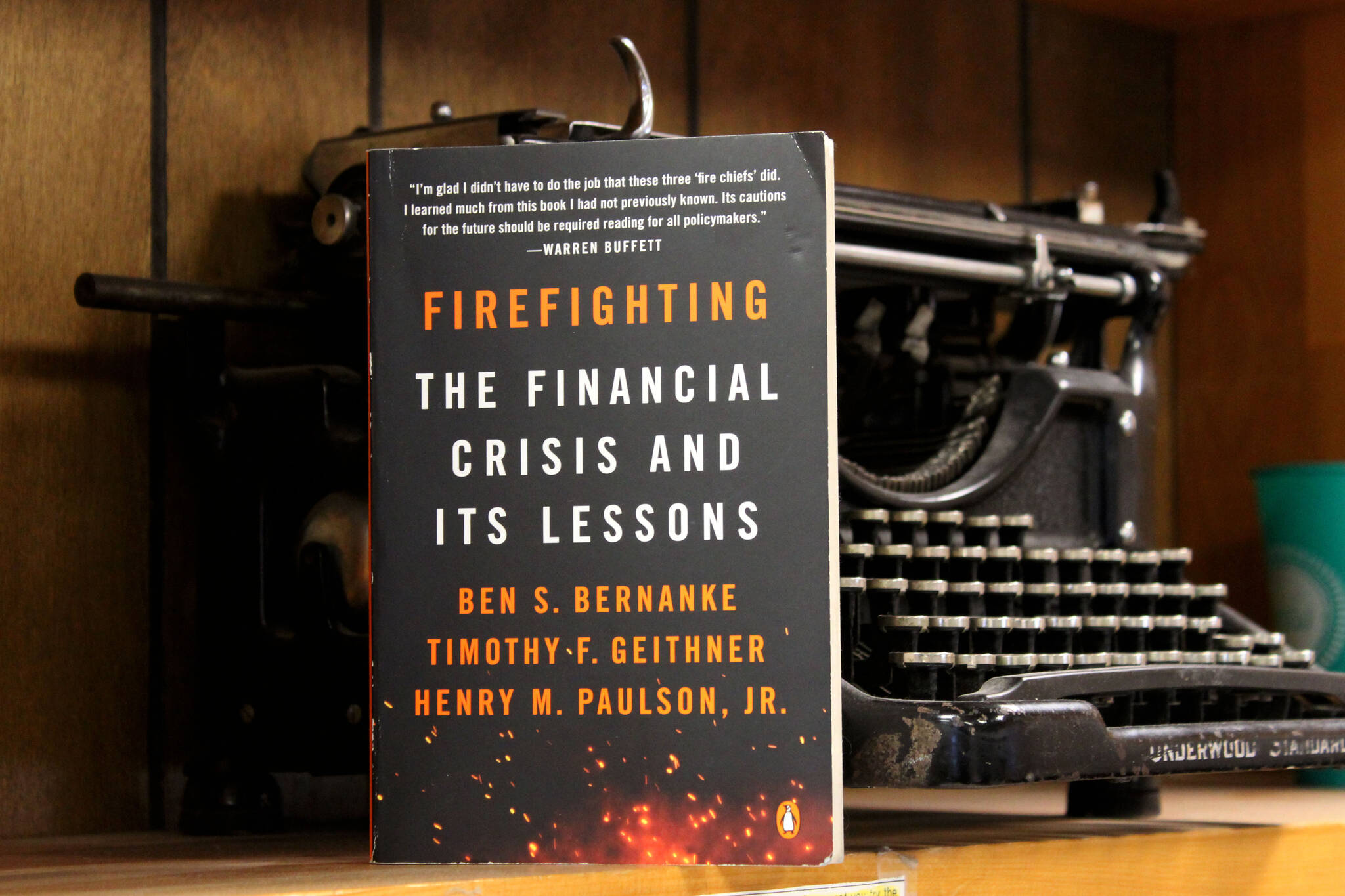 A copy of “Firefighting: the Financial Crisis and Its Lessons” rests against a typewriter on Wednesday, May 4, 2022, in Kenai, Alaska. (Ashlyn O’Hara/Peninsula Clarion)