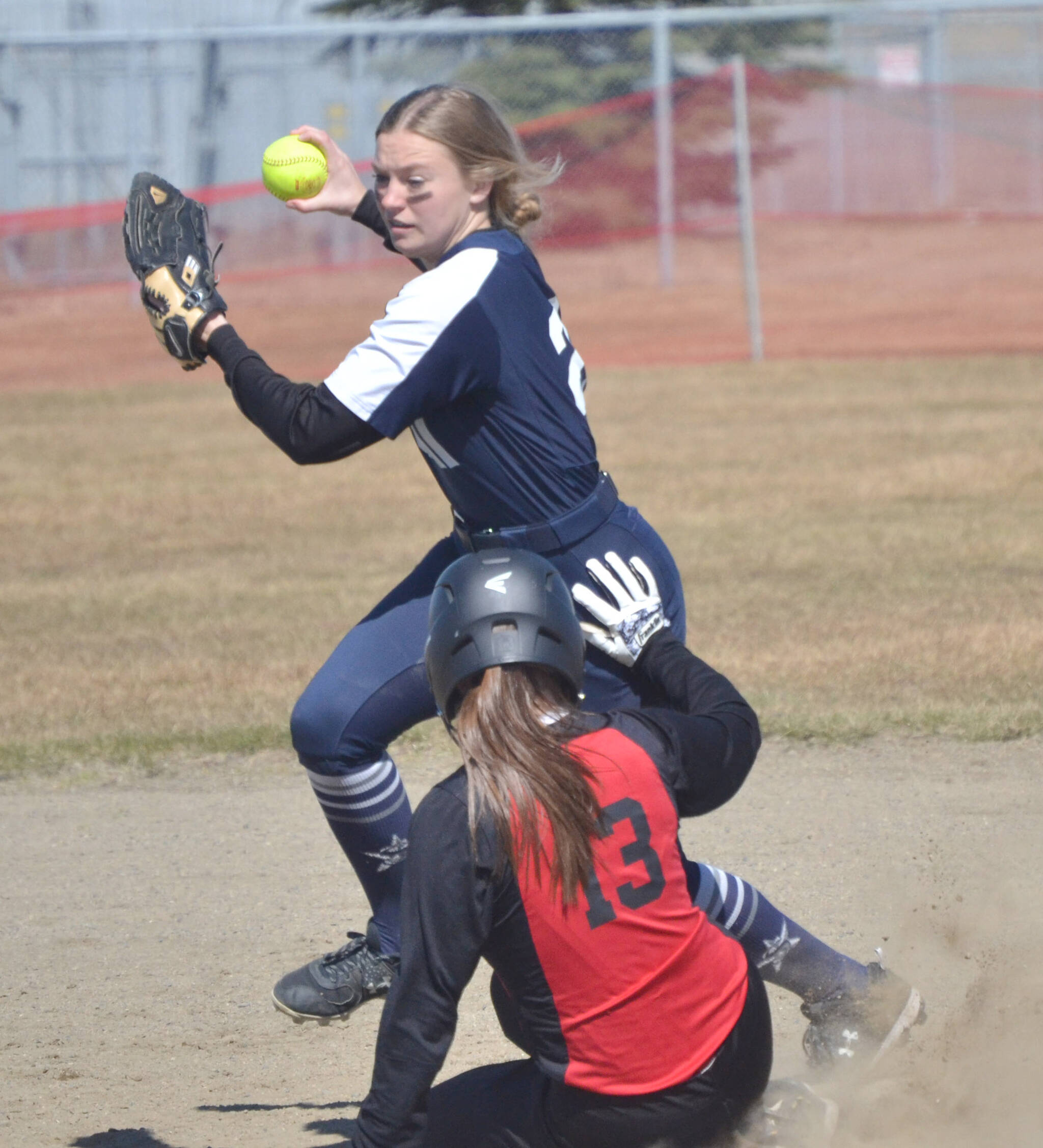 Soldotna second baseman Emily Hinz forces out Kenai’s Avery Ellis at second base Saturday, May 7, 2022, at Steve Shearer Memorial Ball Field in Kenai, Alaska. (Photo by Jeff Helminiak/Peninsula Clarion)