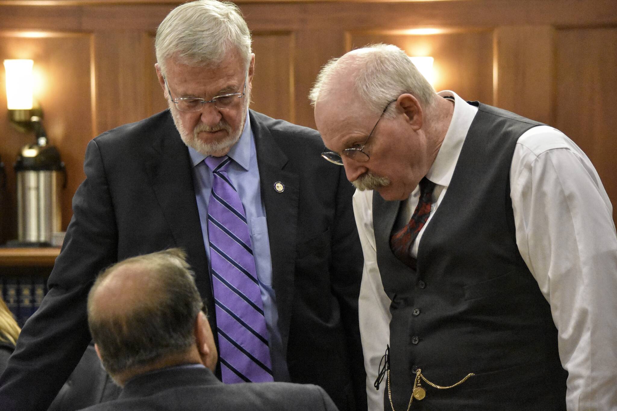 Peter Segall / Juneau Empire
Sen. Gary Stevens, R-Kodiak, and Senate Finance Committee Co-chair Bert Stedman, R-Sitka, speak with Sen. Lyman Hoffman, D-Bethel, during an all-day debate on the state’s budget on the floor of the Alaska State Senate on Tuesday, May 9, 2022.