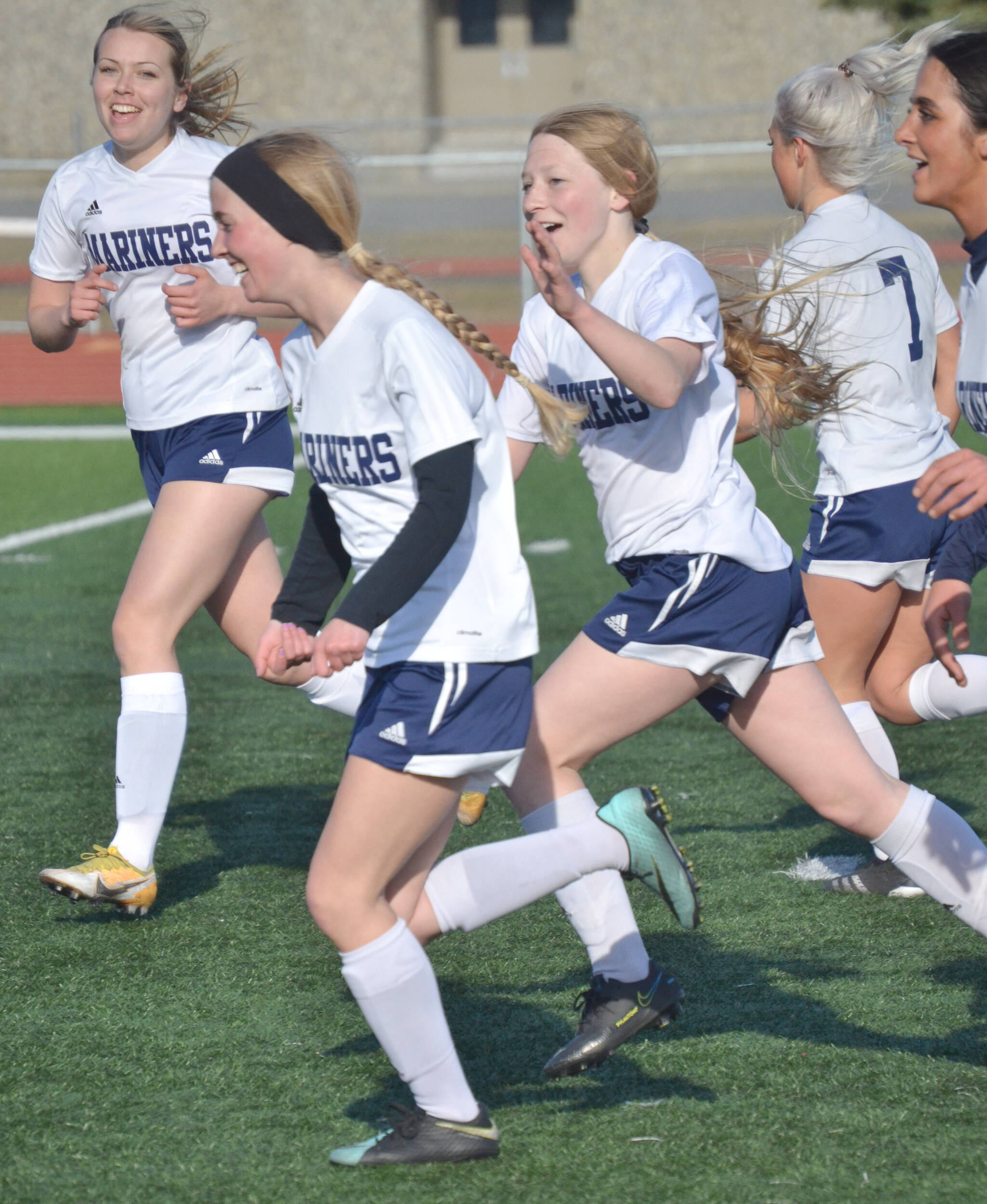 Homer’s Ava Halstead (front) celebrates a first-half goal against Kenai Central on Monday at Ed Hollier Field at Kenai Central High School in Kenai, Alaska. (Photo by Jeff Helminiak/Peninsula Clarion)