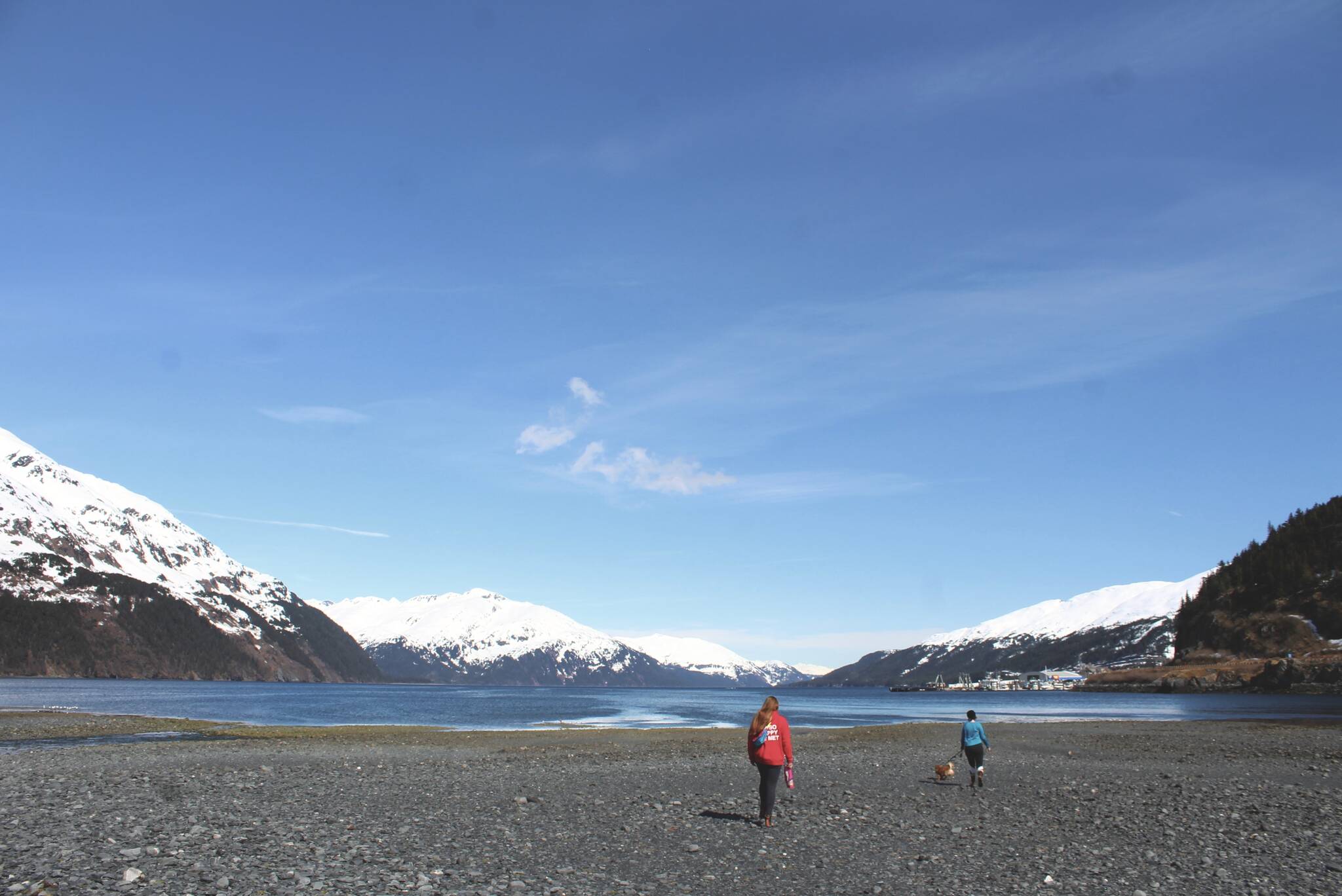 Friends walk at the head of the Passage Canal on Saturday, May 7, 2022 in Whittier, Alaska. (Ashlyn O’Hara/Peninsula Clarion)