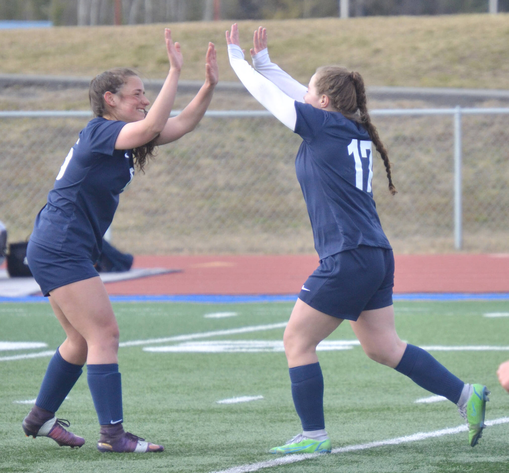 Soldotna’s Katharine Bramante and Liberty Miller celebrate Miller’s goal against Houston on Thursday, May 12, 2022, at Justin Maile Field at Soldotna High School in Soldotna, Alaska. (Photo by Jeff Helminiak/Peninsula Clarion)
