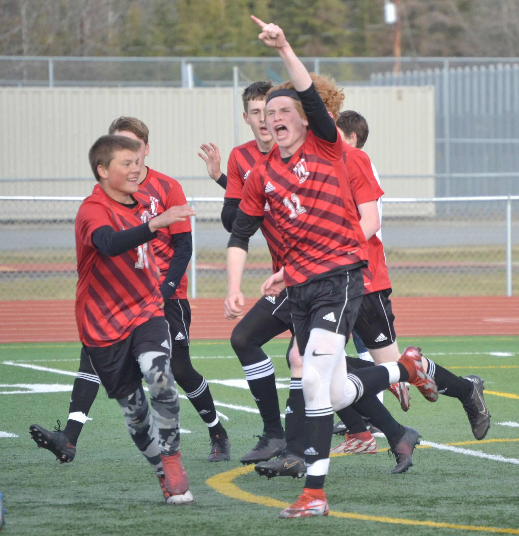 Kenai Central’s Wade James celebrates his first-half goal against Soldotna on Friday, May 13, 2022, at Ed Hollier Field at Kenai Central High School in Kenai, Alaska. (Photo by Jeff Helminiak/Peninsula Clarion)