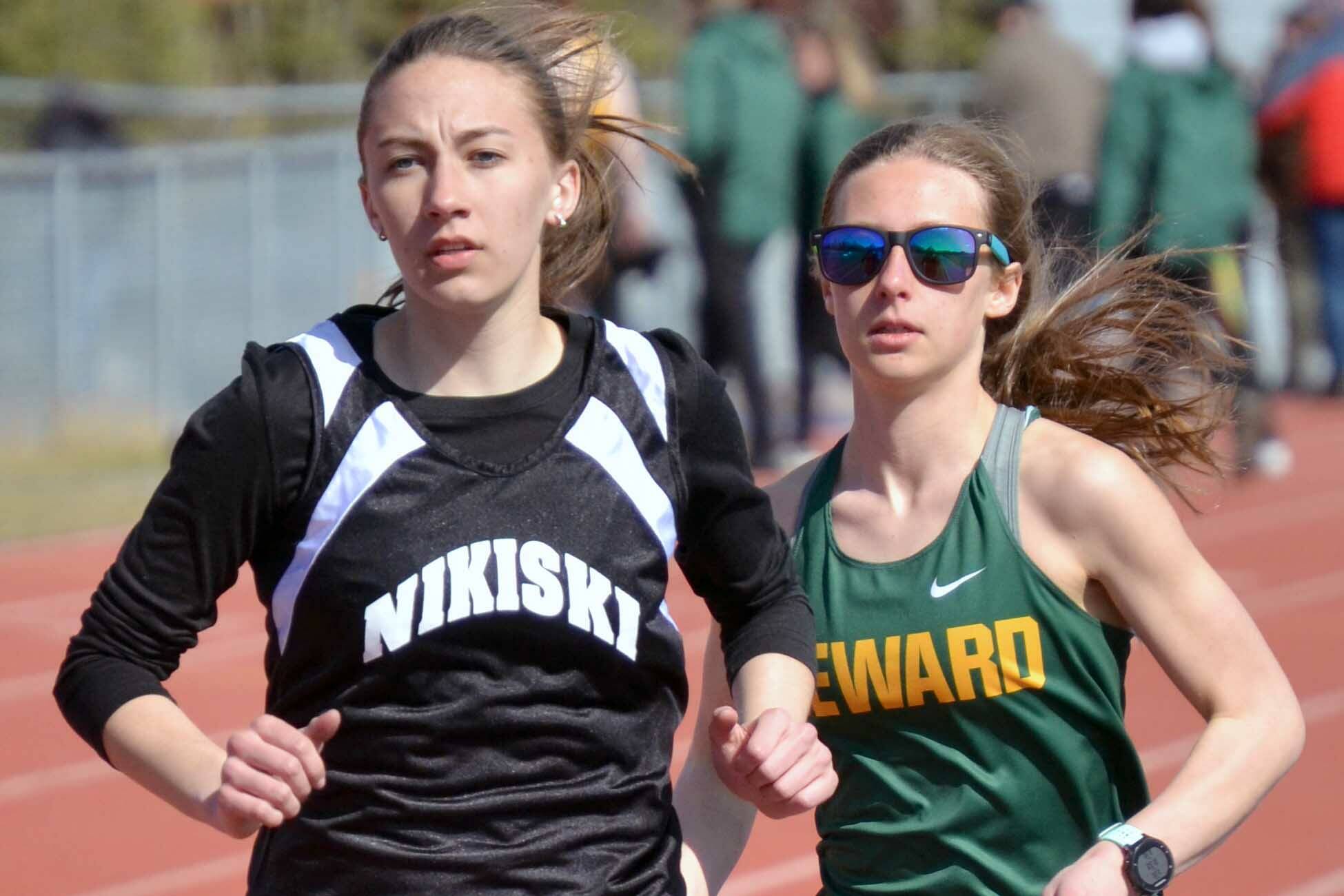 Nikiski's Rylee Ellis and Seward's Hailey Ingalls duel in the 800 meters at the Kenai Peninsula Borough meet Saturday, May 14, 2022, at Justin Maile Field at Soldotna High School in Soldotna, Alaska. (Photo by Jeff Helminiak/Peninsula Clarion)