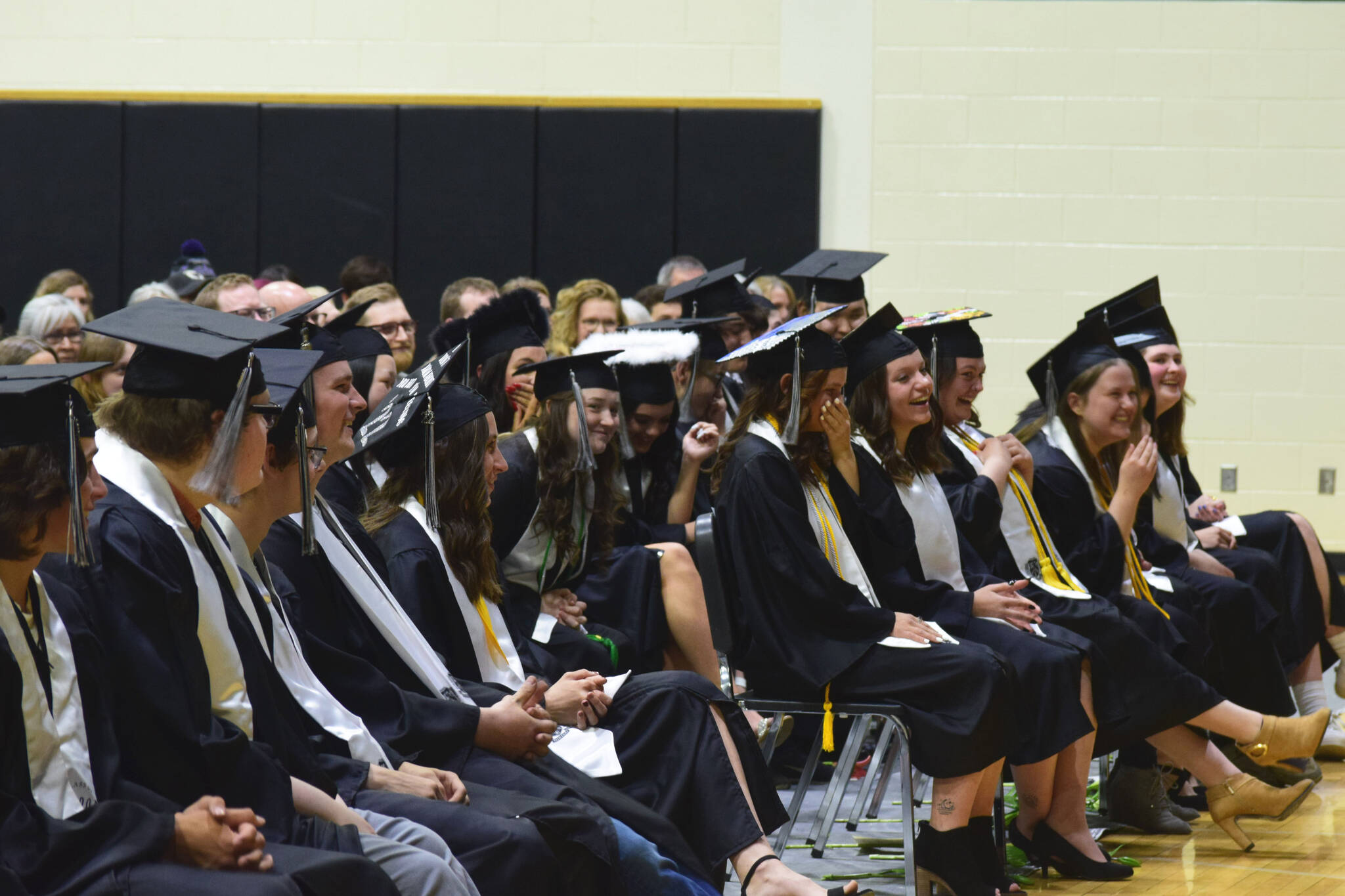 Graduates laugh during teacher Jesse Bjorkman’s 2022 commencement address at Nikiski Middle/High School on Monday, May 16, 2022 in Nikiski, Alaska. (Ashlyn O’Hara/Peninsula Clarion)