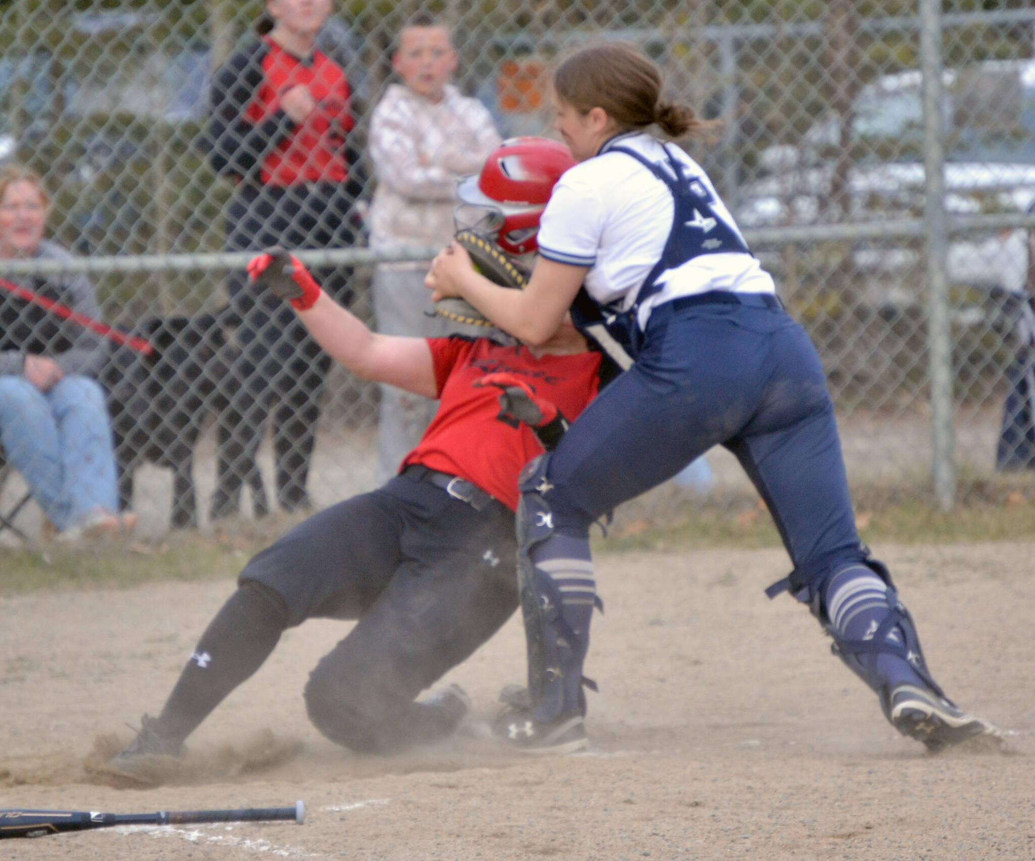 Soldotna catcher Bailey Conner tags out Kenai Central’s Kailey Stynsberg on Monday, May 16, 2022, at the Soldotna Little League fields in Soldotna, Alaska. (Photo by Jeff Helminiak/Peninsula Clarion)