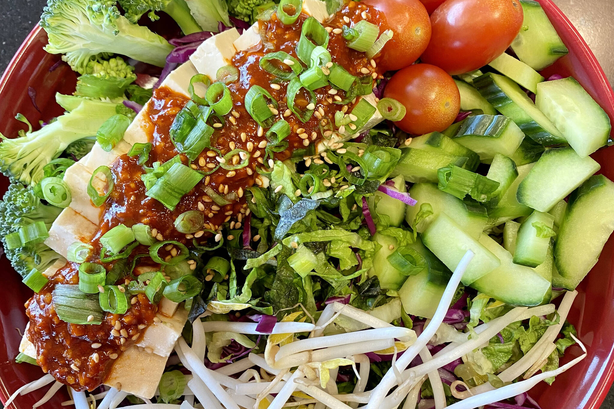 Gochujang dressing spices up tofu, lettuce, veggies and sprouts. (Photo by Tressa Dale/Peninsula Clarion)