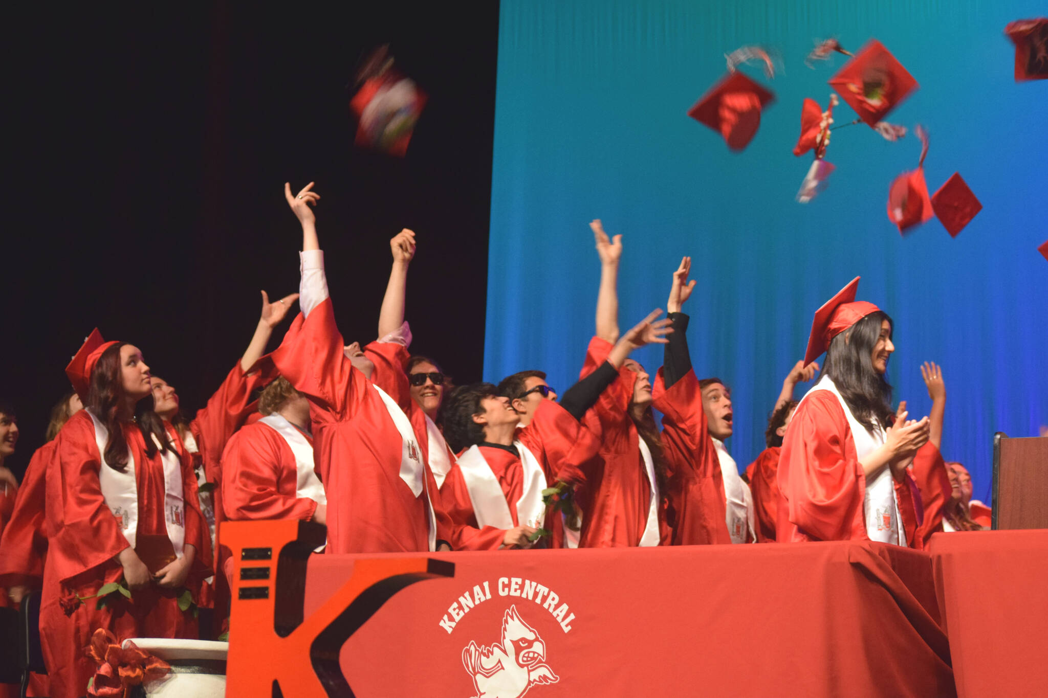 Kenai Central High School graduates throw caps at the end of their commencement ceremony on Tuesday, May 17, 2022, in Kenai, Alaska. (Ashlyn O’Hara/Peninsula Clarion)