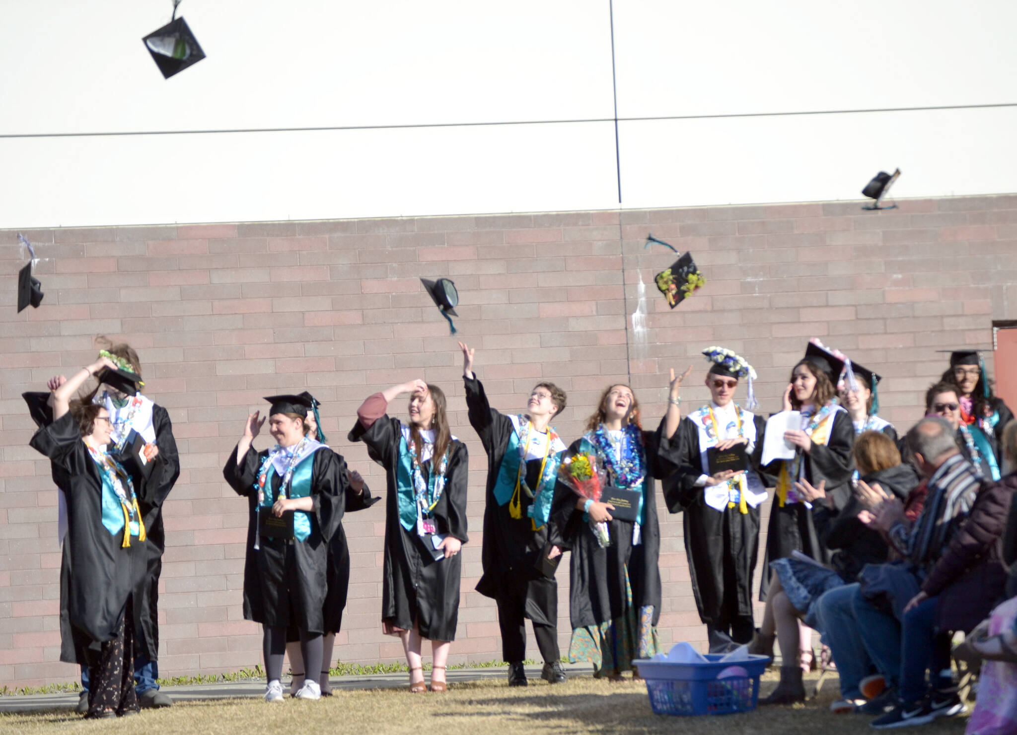 The 2022 graduating class of River City Academy celebrates Tuesday, May 17, 2022, outside of Skyview Middle School just outside of Soldotna, Alaska. (Photo by Jeff Helminiak/Peninsula Clarion)