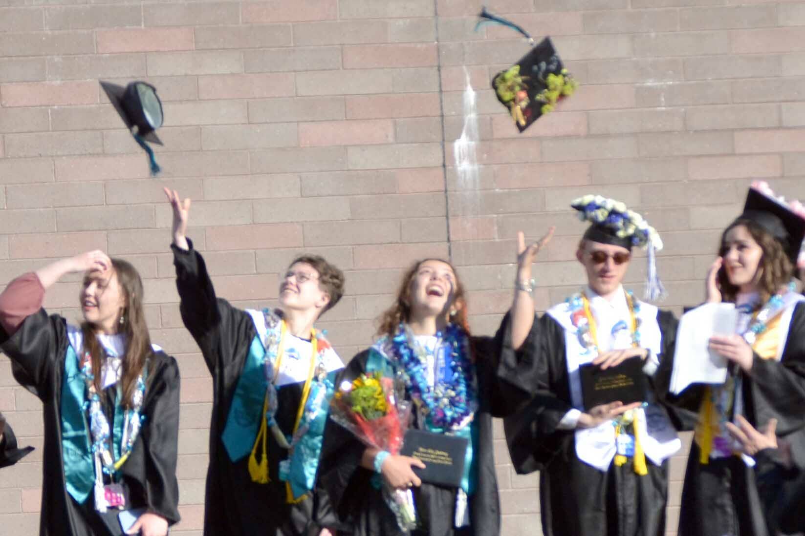 The 2022 graduating class of River City Academy celebrates Tuesday, May 17, 2022, outside of Skyview Middle School just outside of Soldotna, Alaska. (Photo by Jeff Helminiak/Peninsula Clarion)