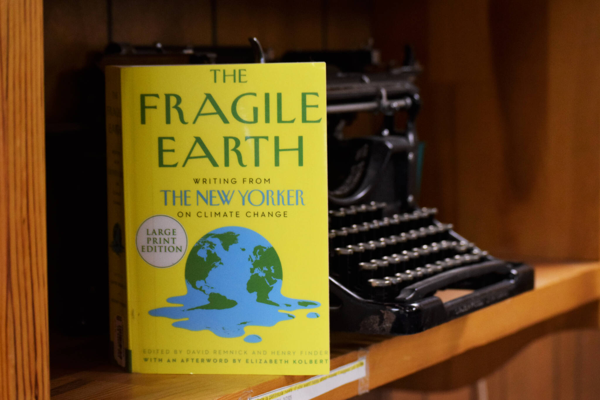 A copy of “The Fragile Earth” rests on a typewriter on Wednesday, May 18, 2022 in Kenai, Alaska. (Ashlyn O’Hara/Peninsula Clarion)