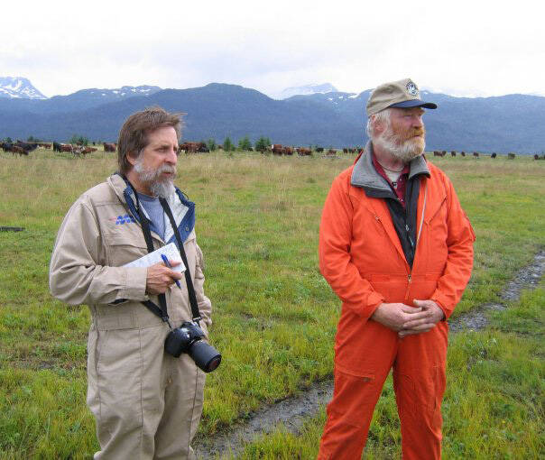 Michael Armstrong, left, wears a flight suit while doing a helicopter tour of agricultural sites in Kachemak Bay in 2008. At right is cattle rancher Chris Rainwater. (Photo provided, U.S. Department of Agrculture)
