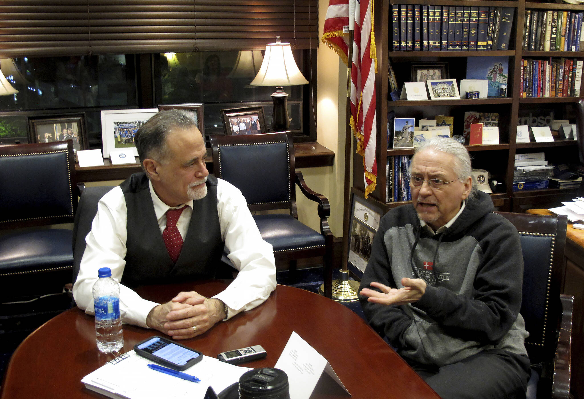 Alaska Senate President Peter Micciche, left, and Senate Minority Leader Tom Begich, right, meet with reporters in Micciche’s office in the early morning hours of Thursday, May 19, 2022, in Juneau, Alaska, after the Legislature ended its regular session. Micciche, a Republican, and Begich, a Democrat, discussed their working relationship, as well as well as parts of the session they were either pleased with or disappointed with. (AP Photo/Becky Bohrer)