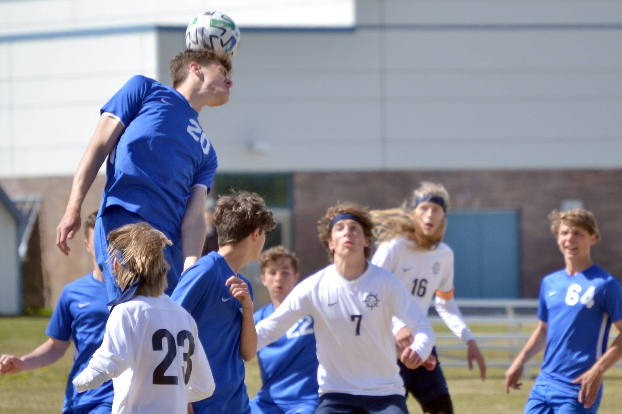 Soldotna's Hamilton Hunt rises above the crowd for a header Friday, May 20, 2022, at the Peninsula Conference soccer tournament at Nikiski High School in Nikiski, Alaska. (Photo by Jeff Helminiak/Peninsula Clarion)