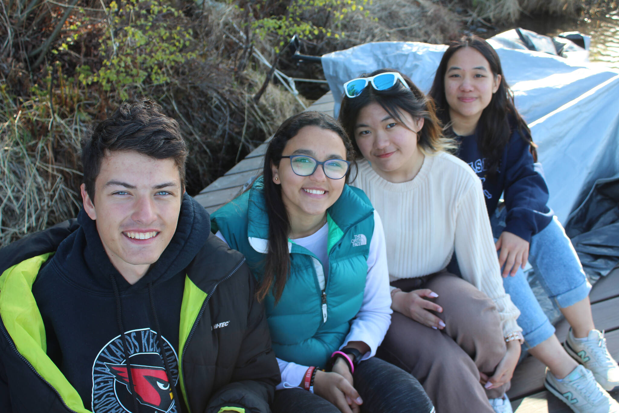 Armands Veksejs, Hager Elserry, Dady Thitisakulwong, and Haewon Hong attend a farewell potluck barbecue in Nikiski on Monday, May 23, 2022. (Camille Botello/Peninsula Clarion)