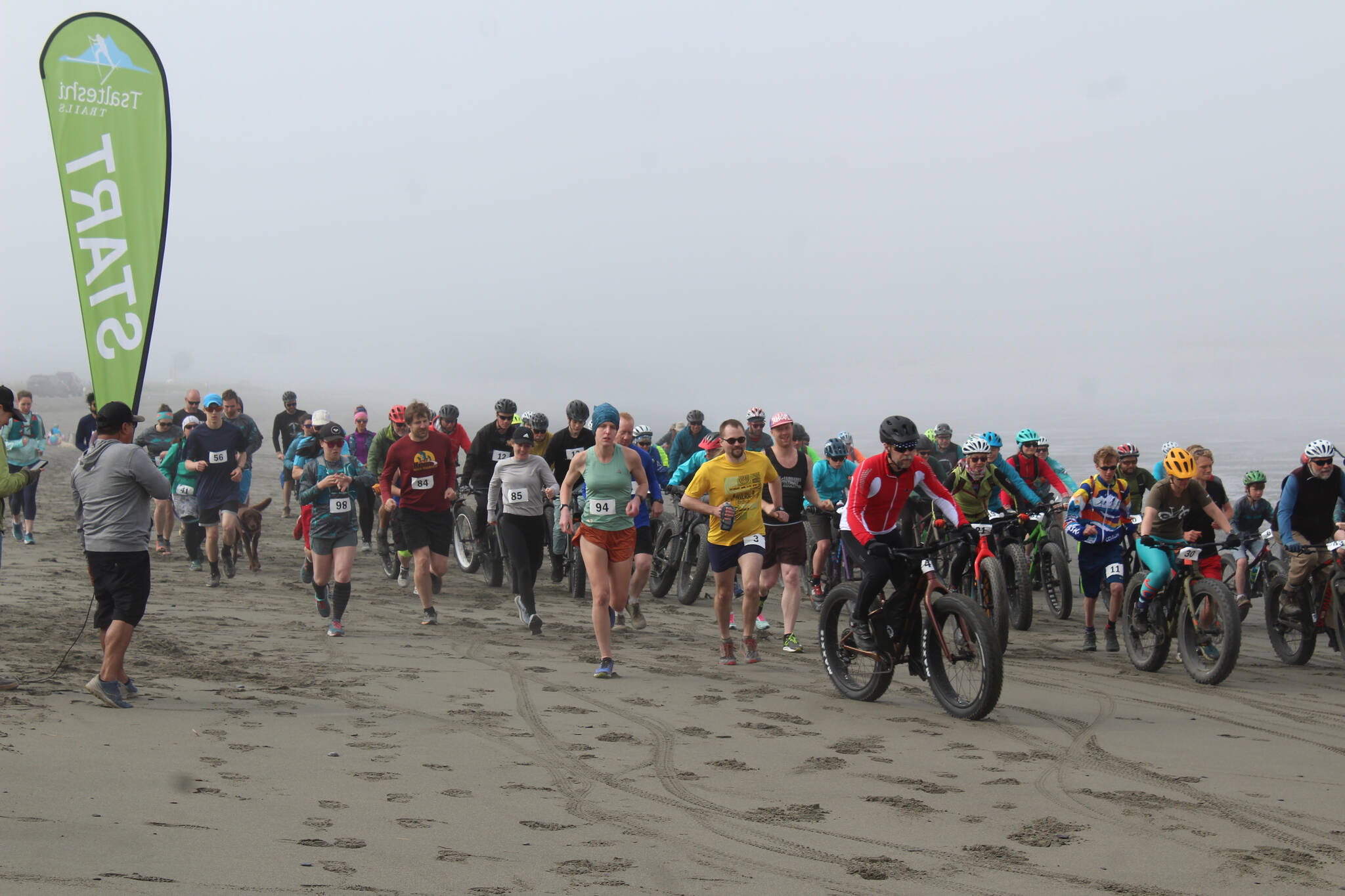 Racers take off from the start line at the Kasilof River Special Use Area for Cook Inletkeeper’s annual Mouth to Mouth Wild Run & Ride on Monday, May 30, 2022. To celebrate National Bike Month, the conservation organization hosted a 10-mile run, 10-mile fat bike ride, and 3-mile run, with all proceeds going toward Cook Inletkeeper’s mission — to ensure healthy salmon in the Cook Inlet watershed. (Camille Botello/Peninsula Clarion)