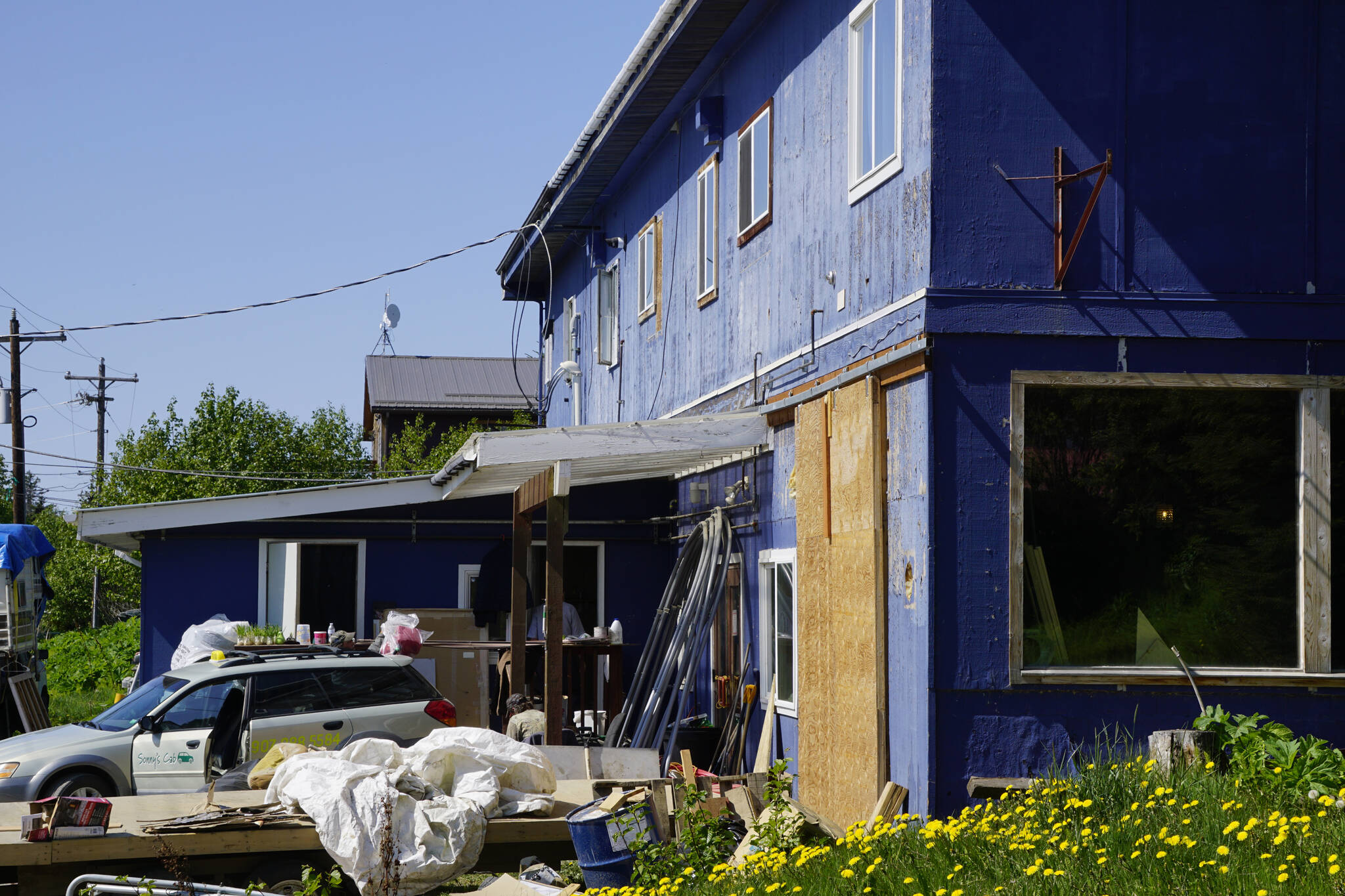 The south side of 397 E. Pioneer Avenue as seen on Friday, May 27, 2022. The barn door to the right was cut into the wall of the former Refuge Chapel, a modifcation other tenants of the building claimed had been done in violation of the business condominium association rules. (Photo by Michael Armstrong/Homer News)