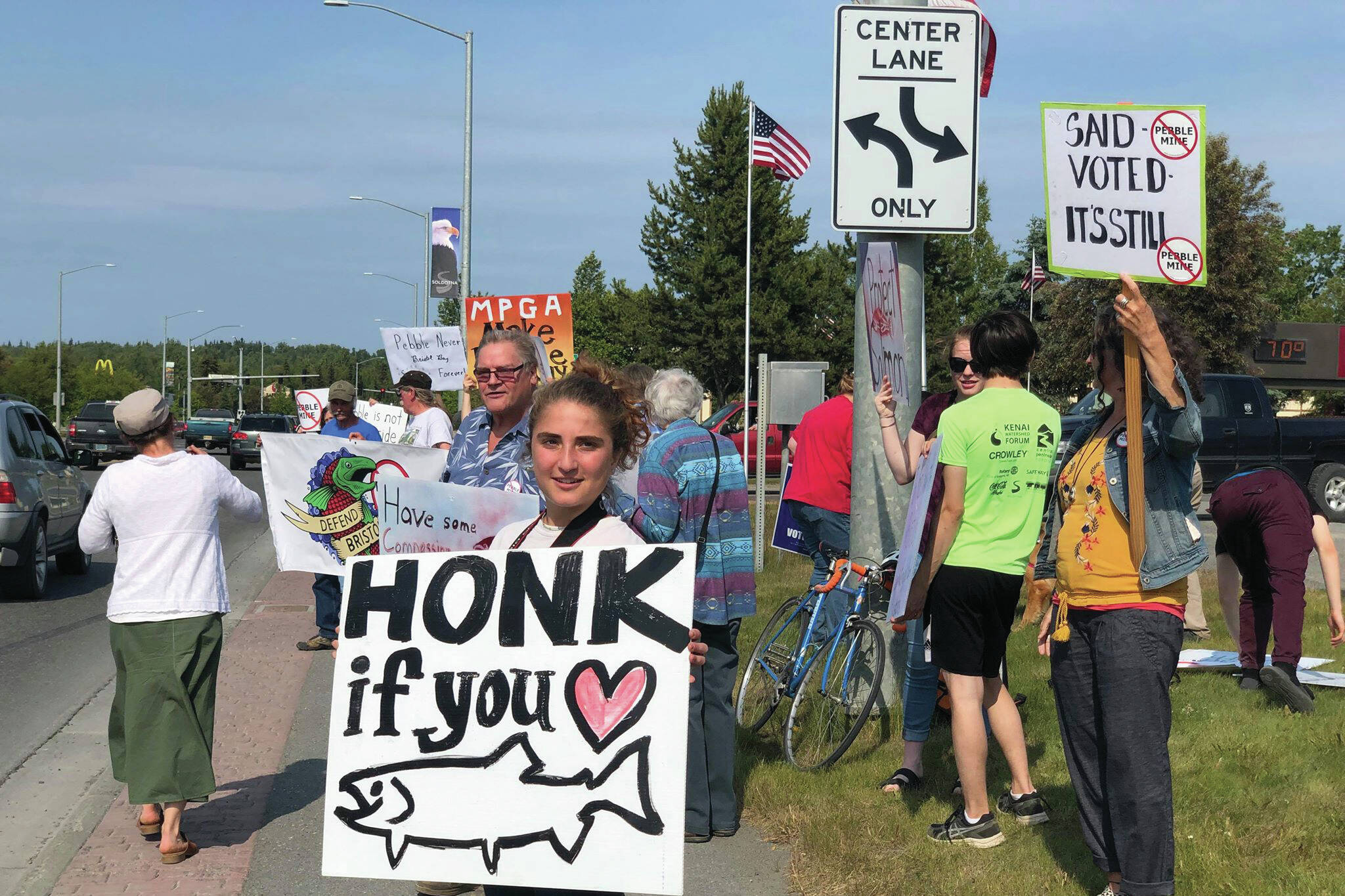 Residents line the Sterling Highway, in front of Sen. Lisa Murkowski’s office to oppose the Pebble Mine on Wednesday, June 26, 2019, in Soldotna, Alaska. (Photo by Victoria Petersen/Peninsula Clarion)