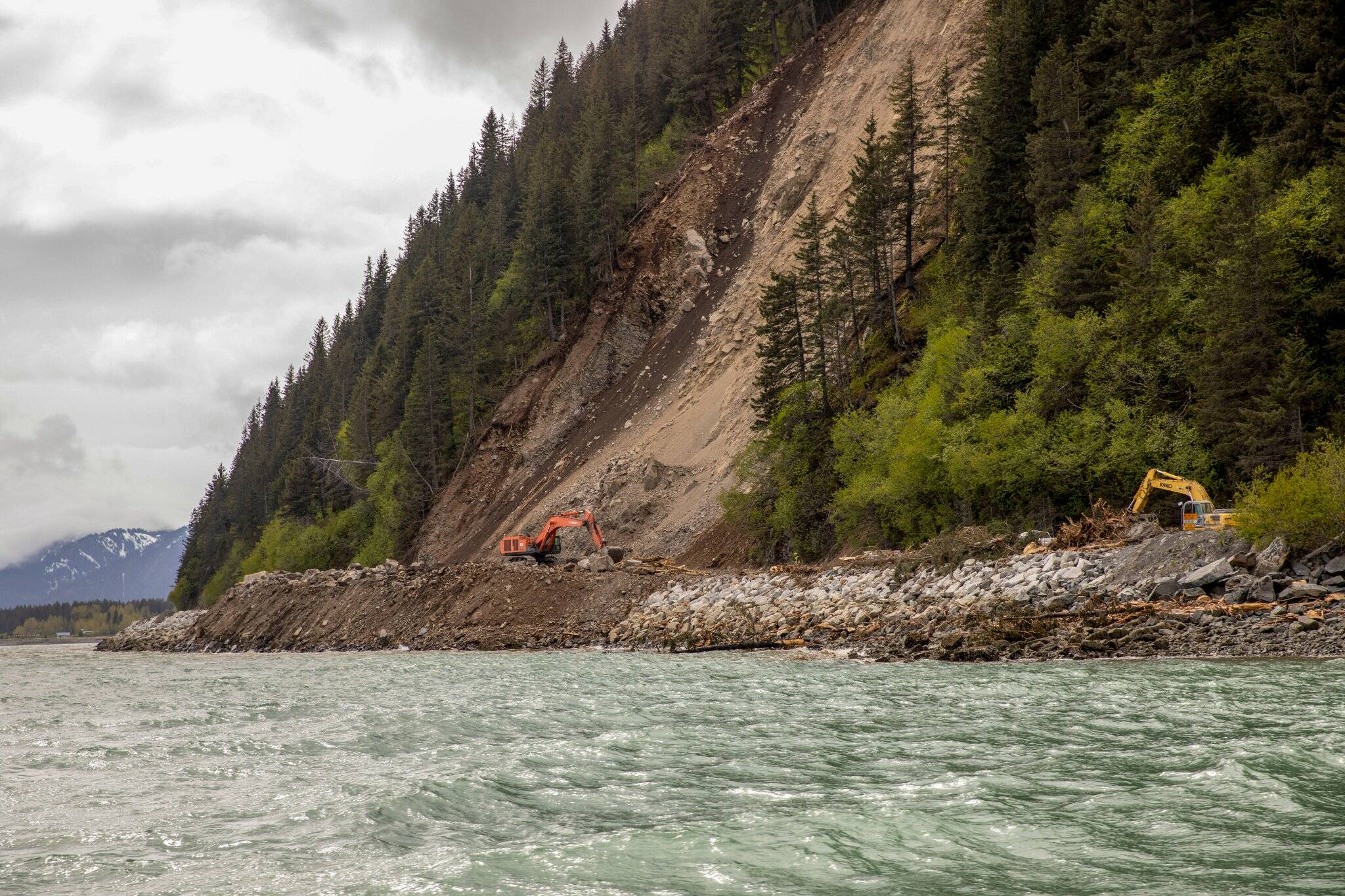 Employees of Metco Alaska work to remove debris from the Lowell Point Road May 23, 2022, following the May 7 Bear Mountain landslide that blocked the road and access to and from the community of Lowell Point. (Photo and caption courtesy of the Kenai Peninsula Borough)
