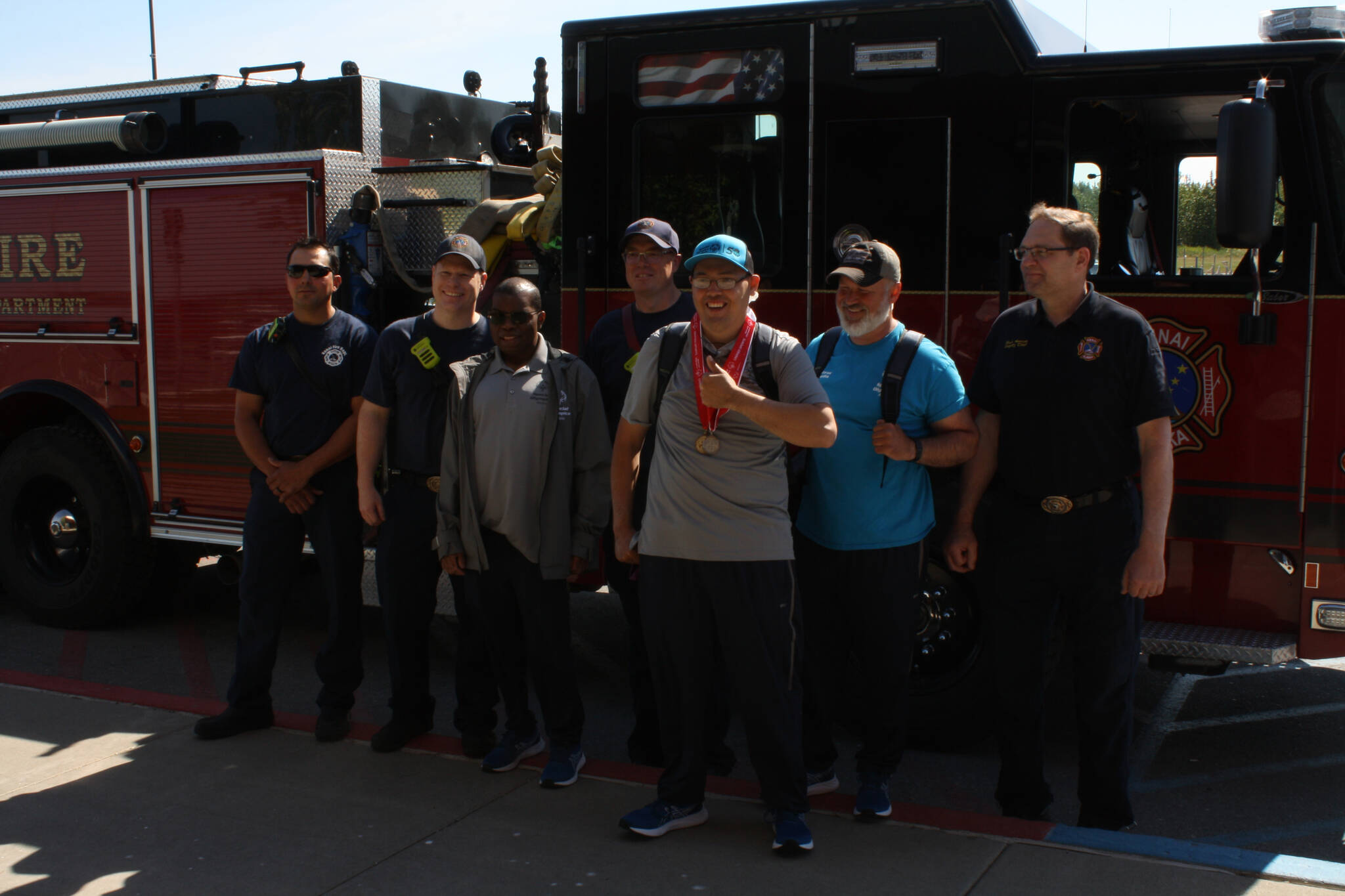 Darryl Magen, front left, and Josh Delie, front right, start their journey from the Kenai Municipal Airport on Friday, June 3, 2022 to this year’s Special Olympics USA Games in Orlando, Florida. (Camille Botello/Peninsula Clarion)