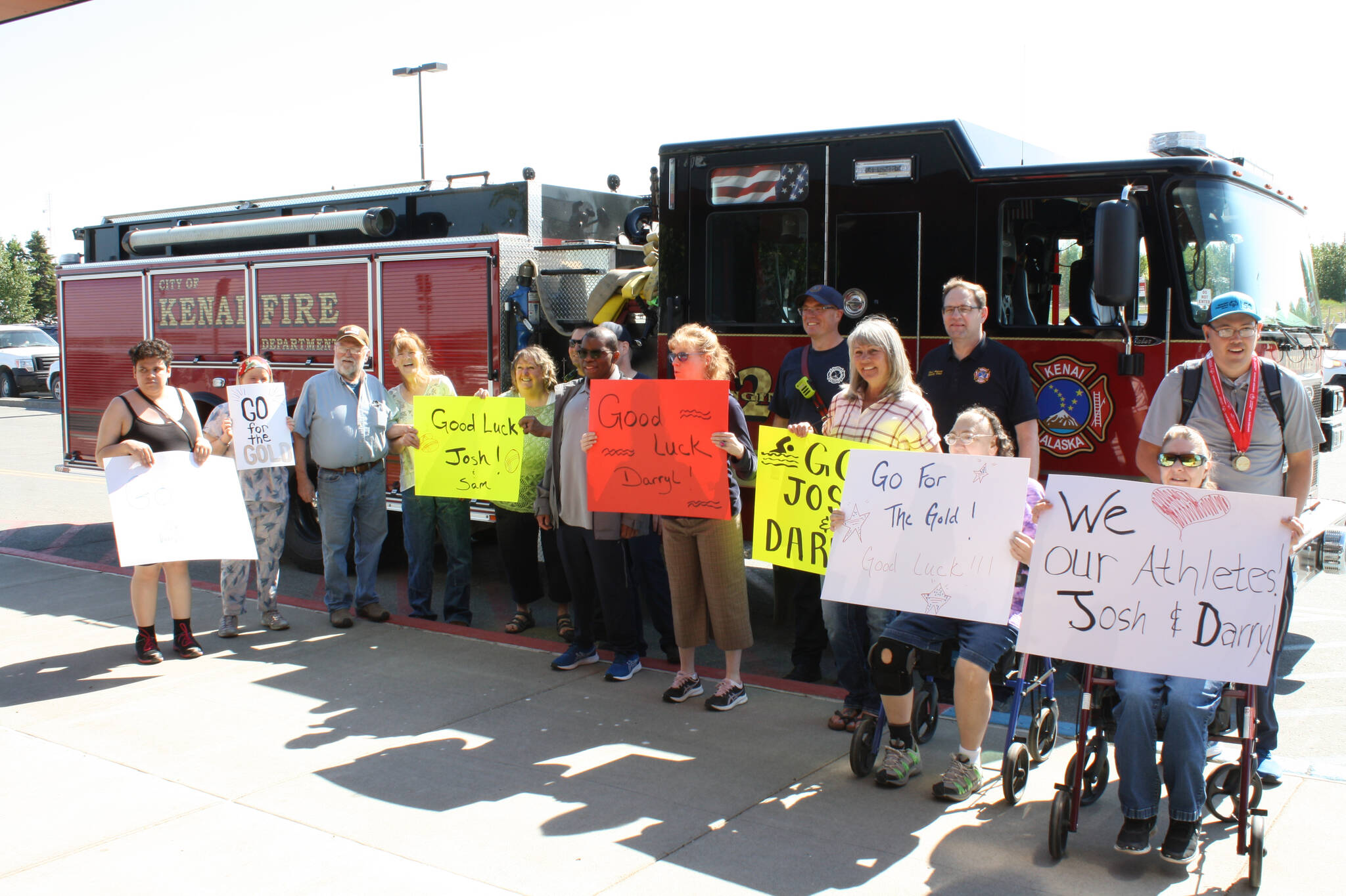 Darryl Magen, center, and Josh Delie, far right, start their journey from the Kenai Municipal Airport on Friday, June 3, 2022 to this year’s Special Olympics USA Games in Orlando, Florida. (Camille Botello/Peninsula Clarion)