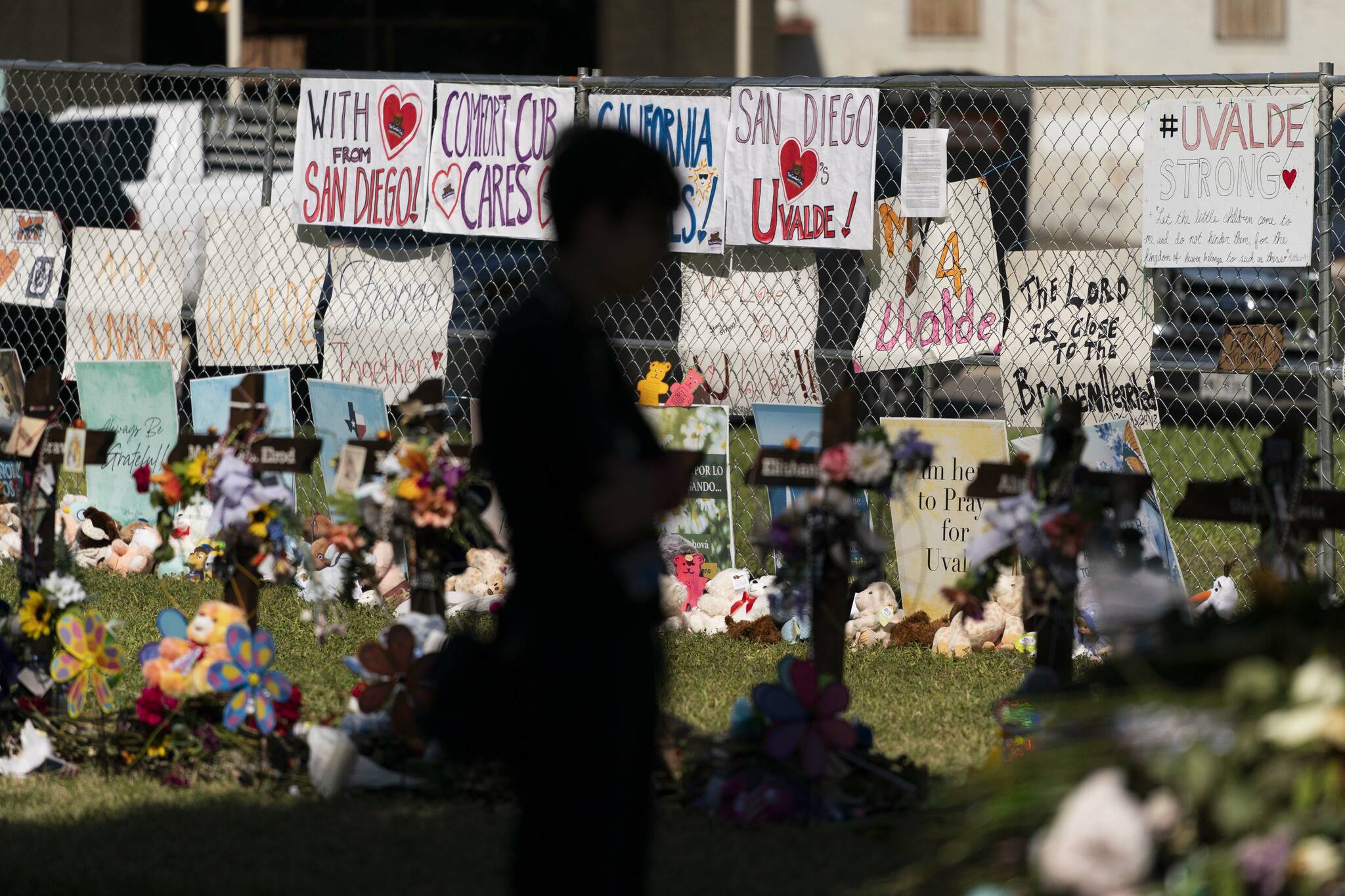 A woman visits a memorial honoring the victims killed in last weeks elementary school shooting in Uvalde, Texas, Friday, June 3, 2022. Its hard to say exactly when some Texas educators began to feel like they were under siege, but the massacre of 19 students and two teachers at Robb Elementary School is only the latest, horrific episode in a string of events dating back years. (AP Photo/Jae C. Hong)